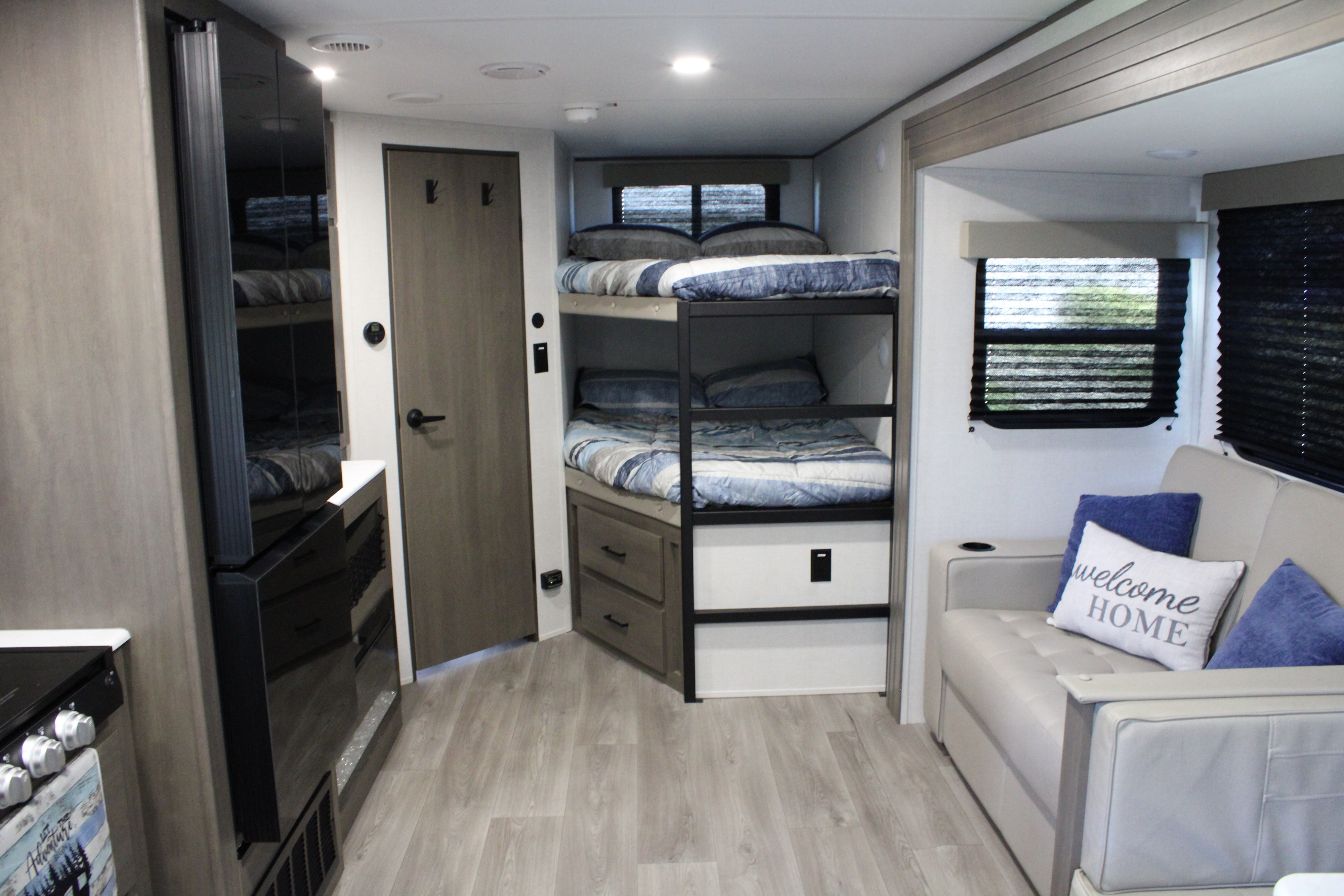 Modern RV rental interior with cozy bunk beds, a comfy sofa, and smart compact living design. Ideal for family trips.. Grand Design Transcend Xplor 2026