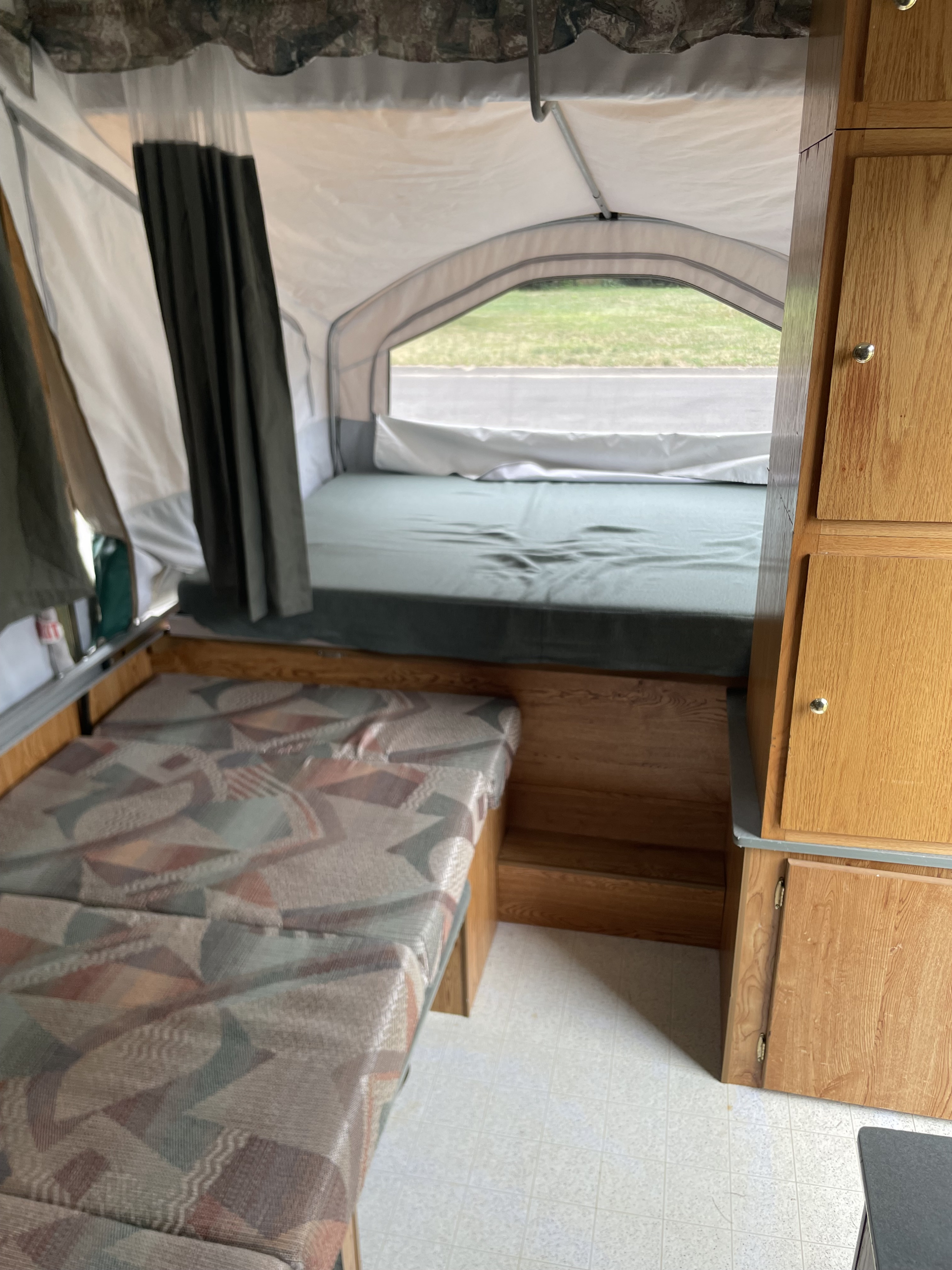 RV rental interior: A bed, patterned dinette, and cabinets offer comfortable space for your next getaway.. Viking Epic 2000