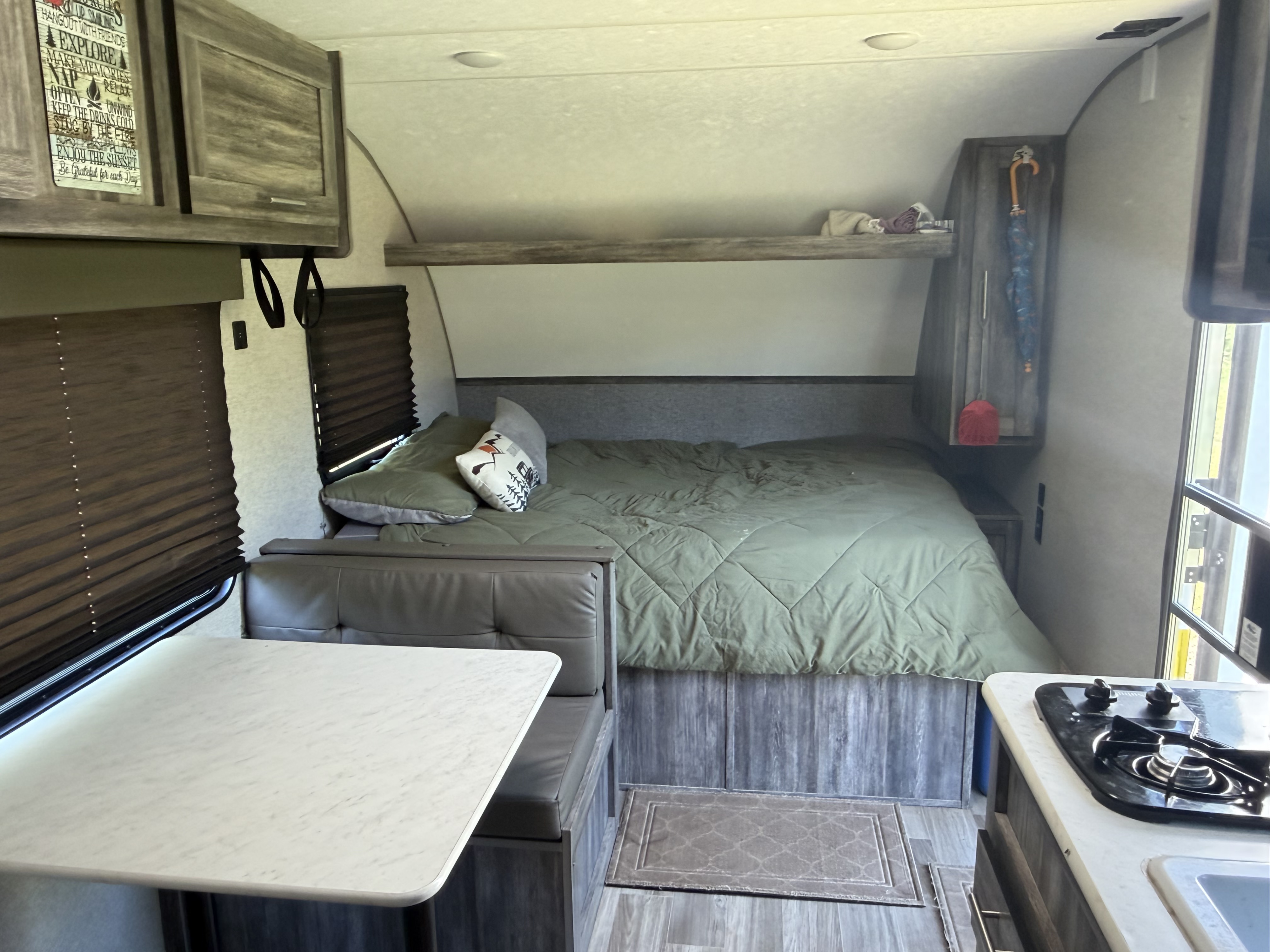 Cozy rv rental interior with a comfy bed, dinette, and compact kitchen. Perfect for adventures on the road.. Forest River Salem FSX 2020