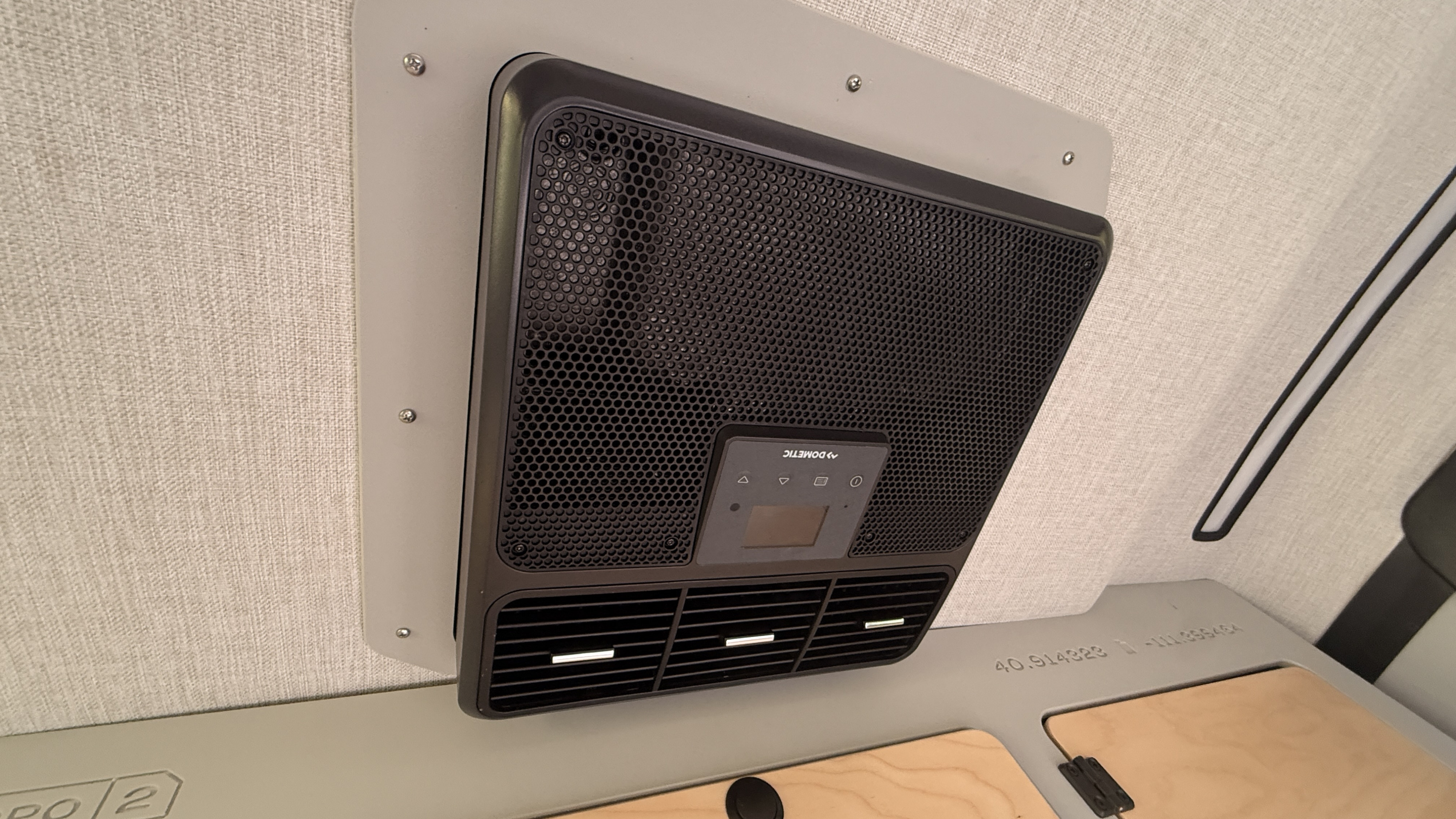 Stay cool in your rv rental! Close-up of a Dometic AC unit with vents & controls inside the modern cabin.. Escapod Topo 2 2023