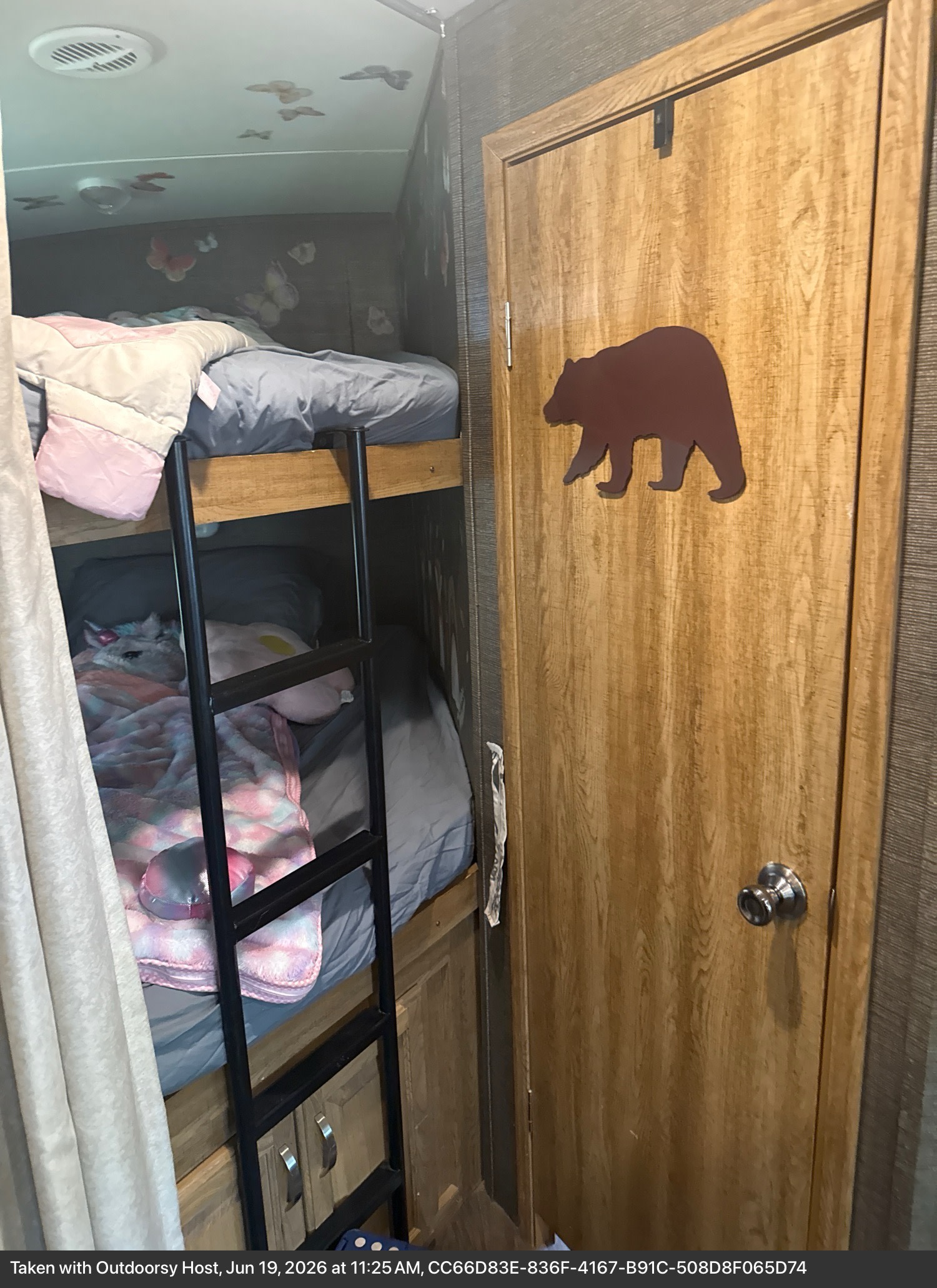 This RV rental features cozy bunk beds with a unicorn plushie & colorful blanket, butterfly decals, and a bear-decorated door.. Keystone RV Laredo 2015