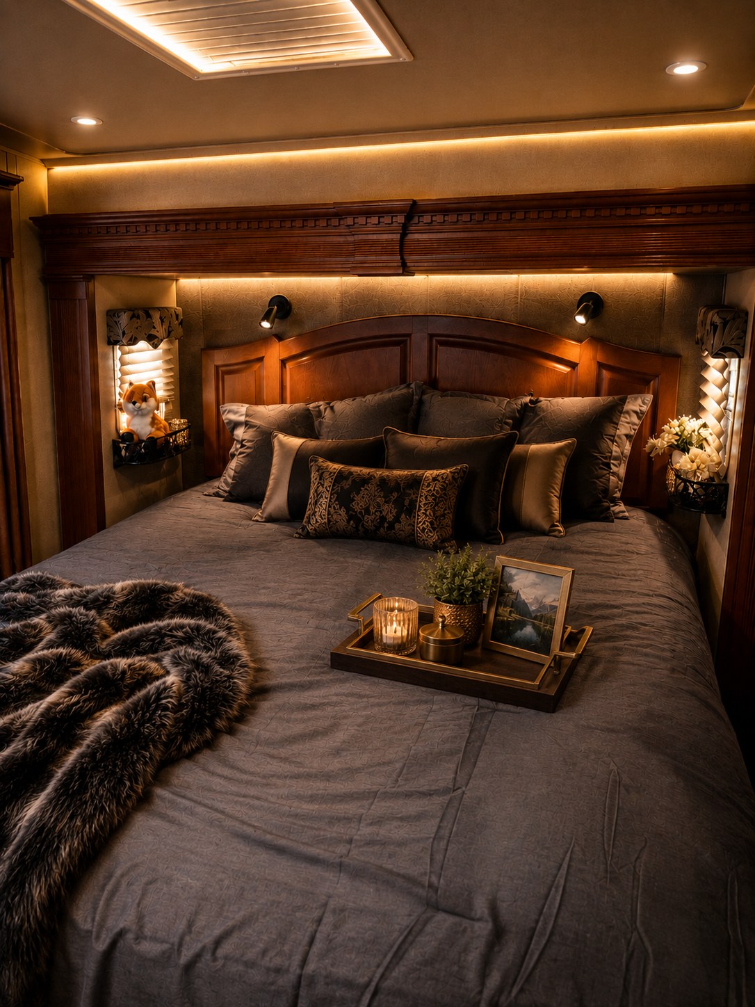 Discover comfort in this inviting RV rental bedroom, featuring plush bedding, warm accent lighting, and elegant decor.. Arctic Fox Silver Fox Edition 2015