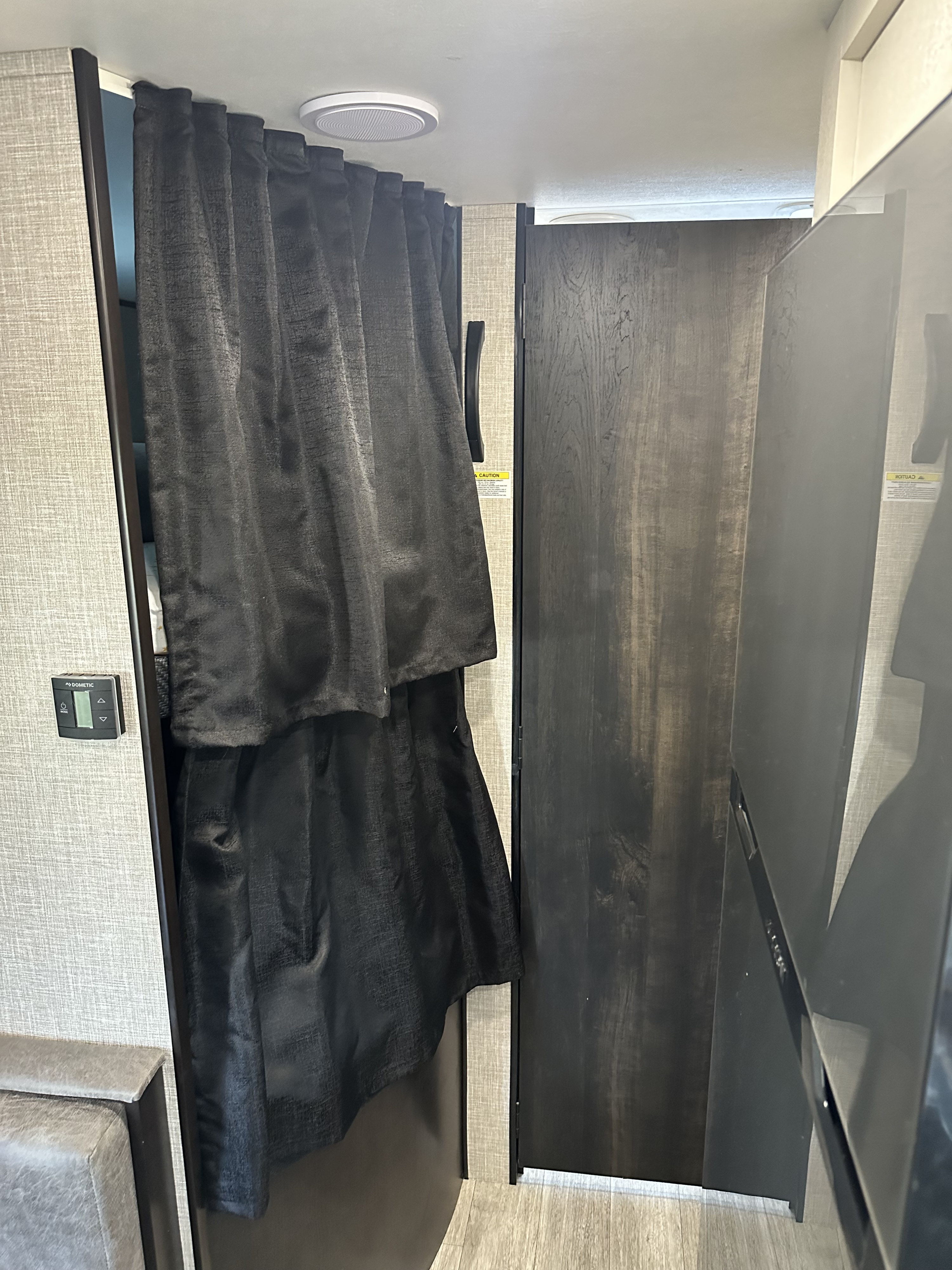 Experience privacy in this RV rental with a dark pull-out curtain for the sleeping area, featuring a Dometic climate control.. Jayco Jay Flight 2023