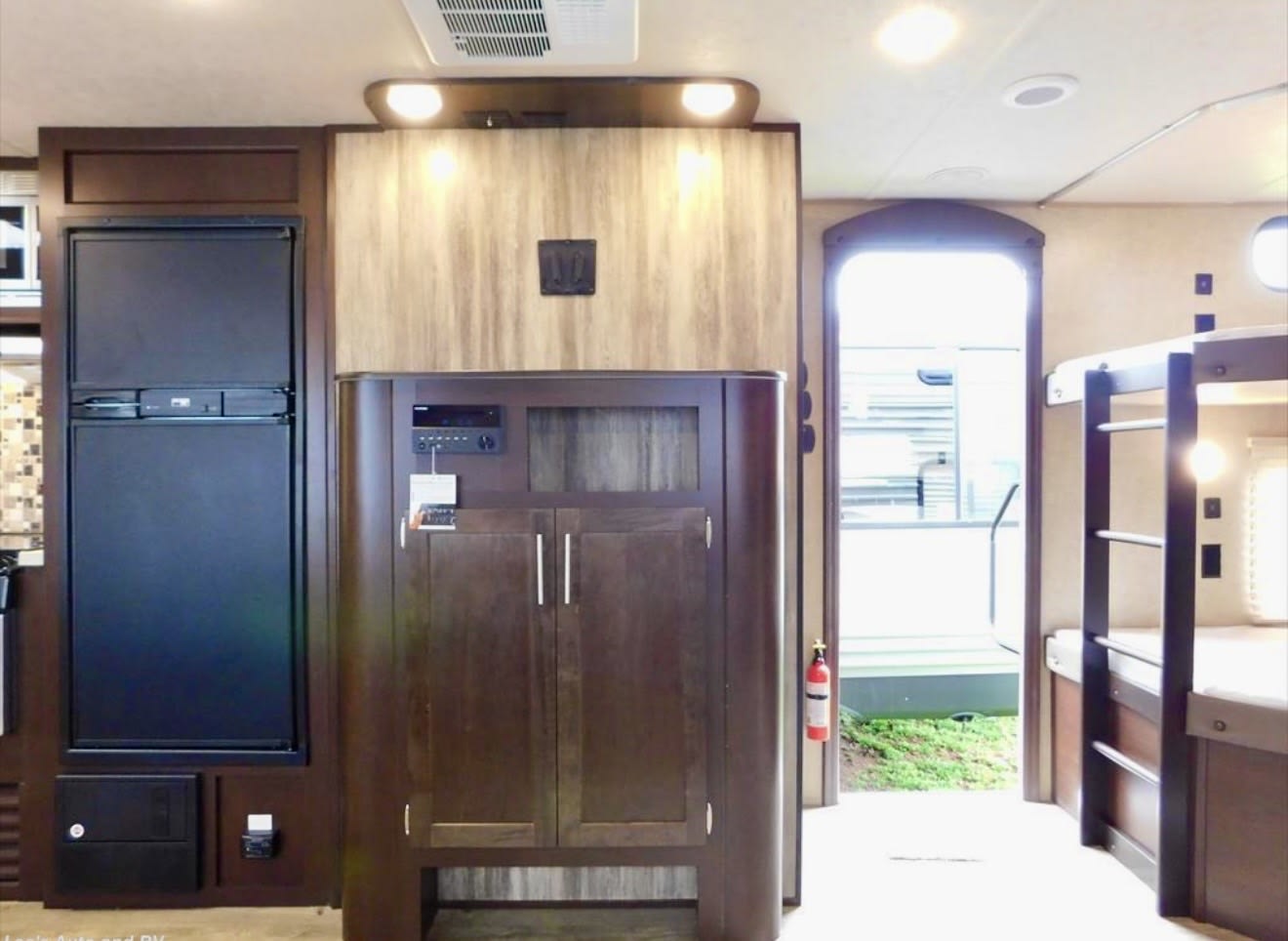 Explore this spacious RV rental interior! Features a large fridge, entertainment center, bunk beds, and safe exit.. Forest River Cherokee 2018