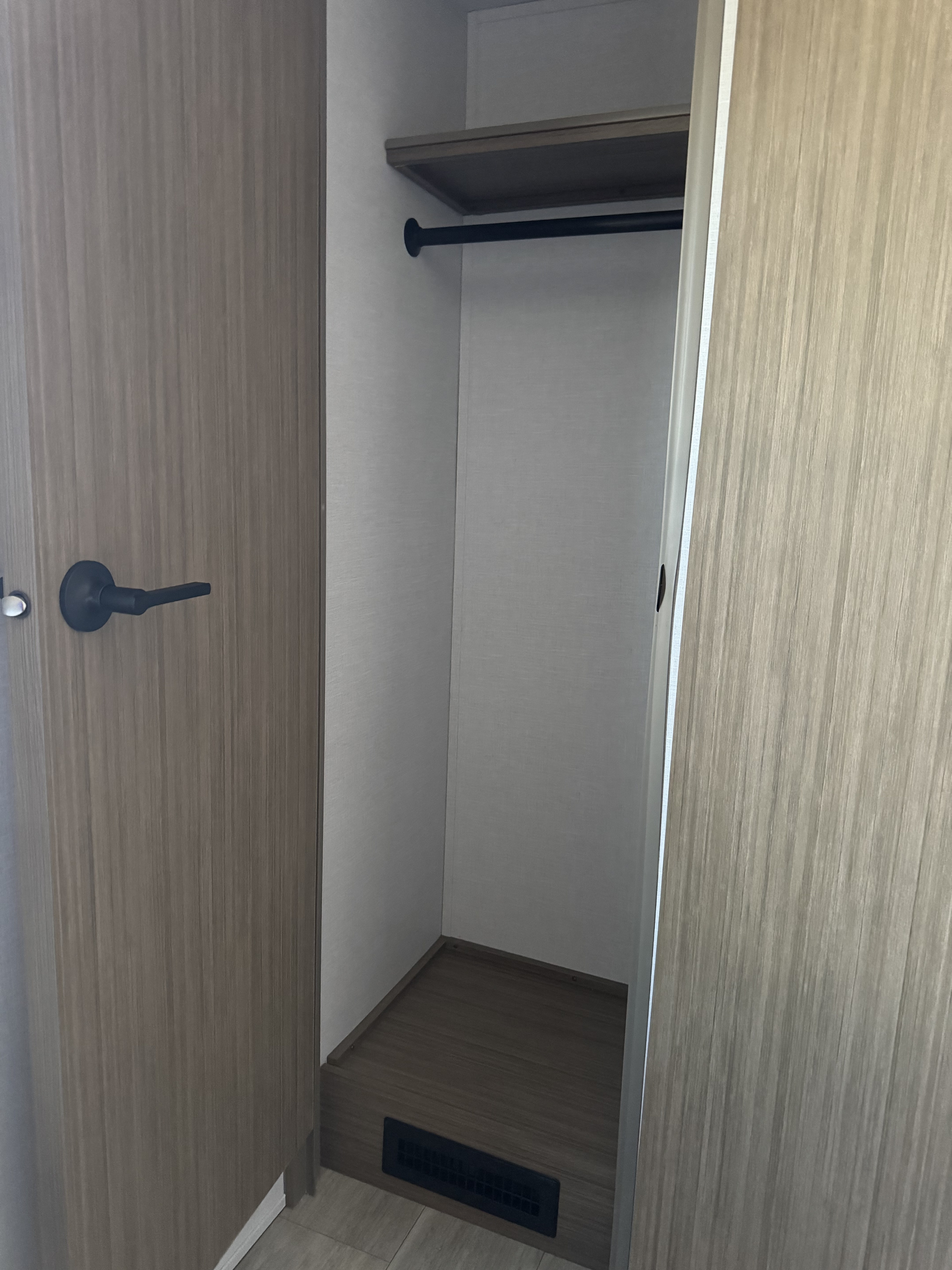 RV rental closet with hanging rod, shelf, and floor vent, showing ample storage space.. Forest River Salem Cruise-Lite 2025