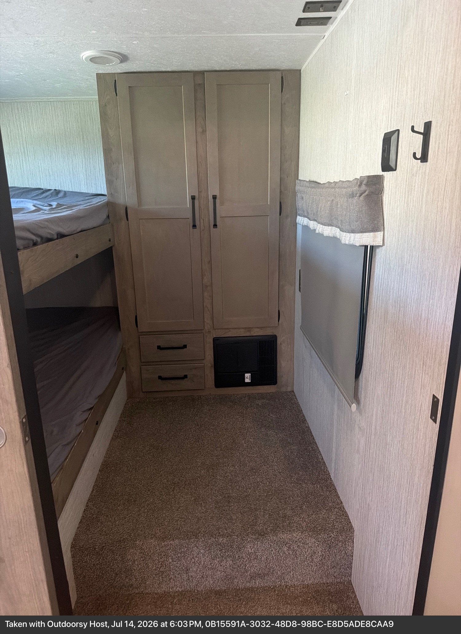 Cozy RV rental bunk bed area featuring two beds, a wardrobe with drawers, & a window. Ideal for family adventures.. Forest River Palomino Puma 2021