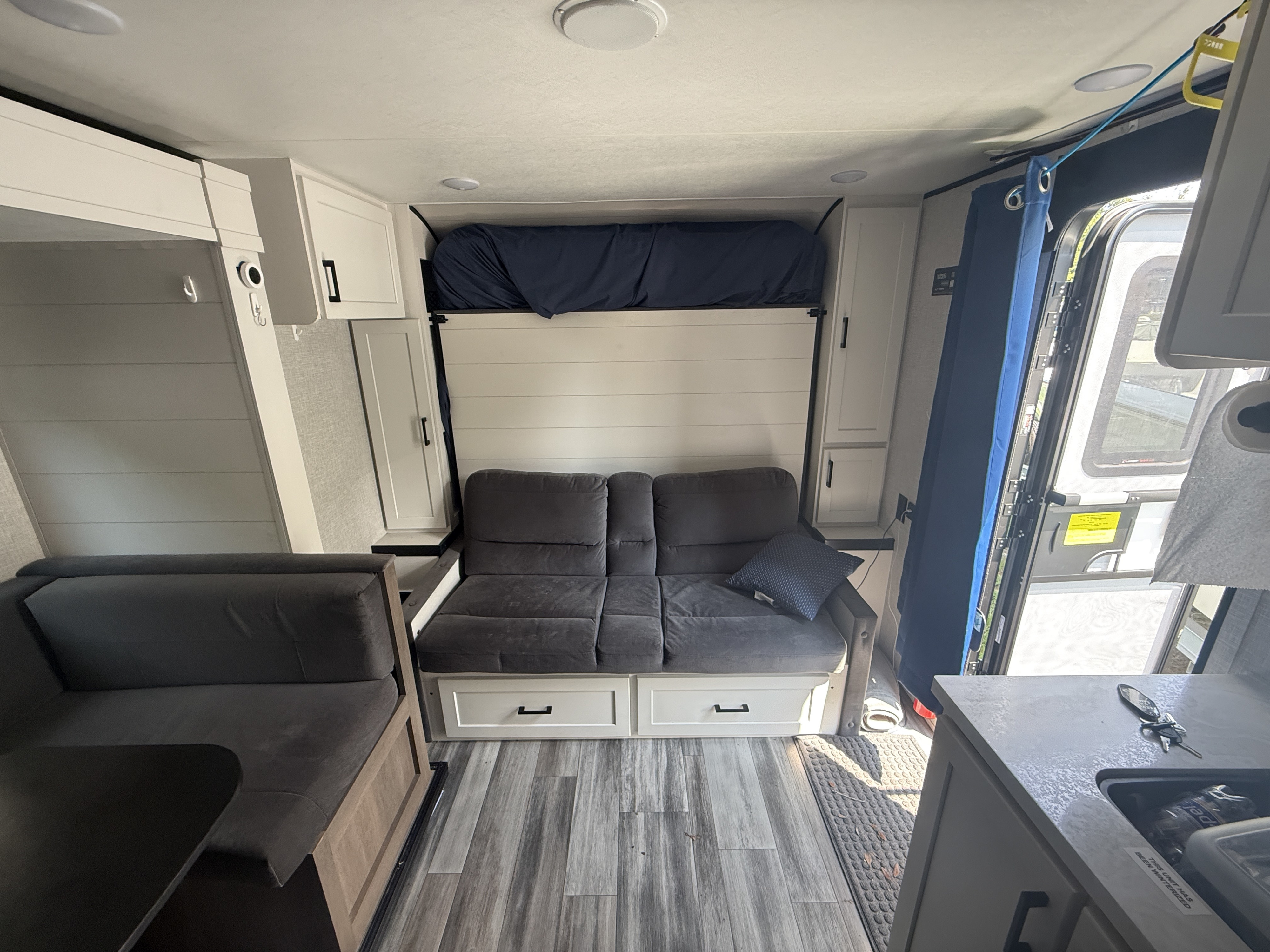 Cozy RV rental interior featuring a drop-down bunk, sofa bed, dinette, and kitchenette.. Jayco Jay Flight SLX 2025