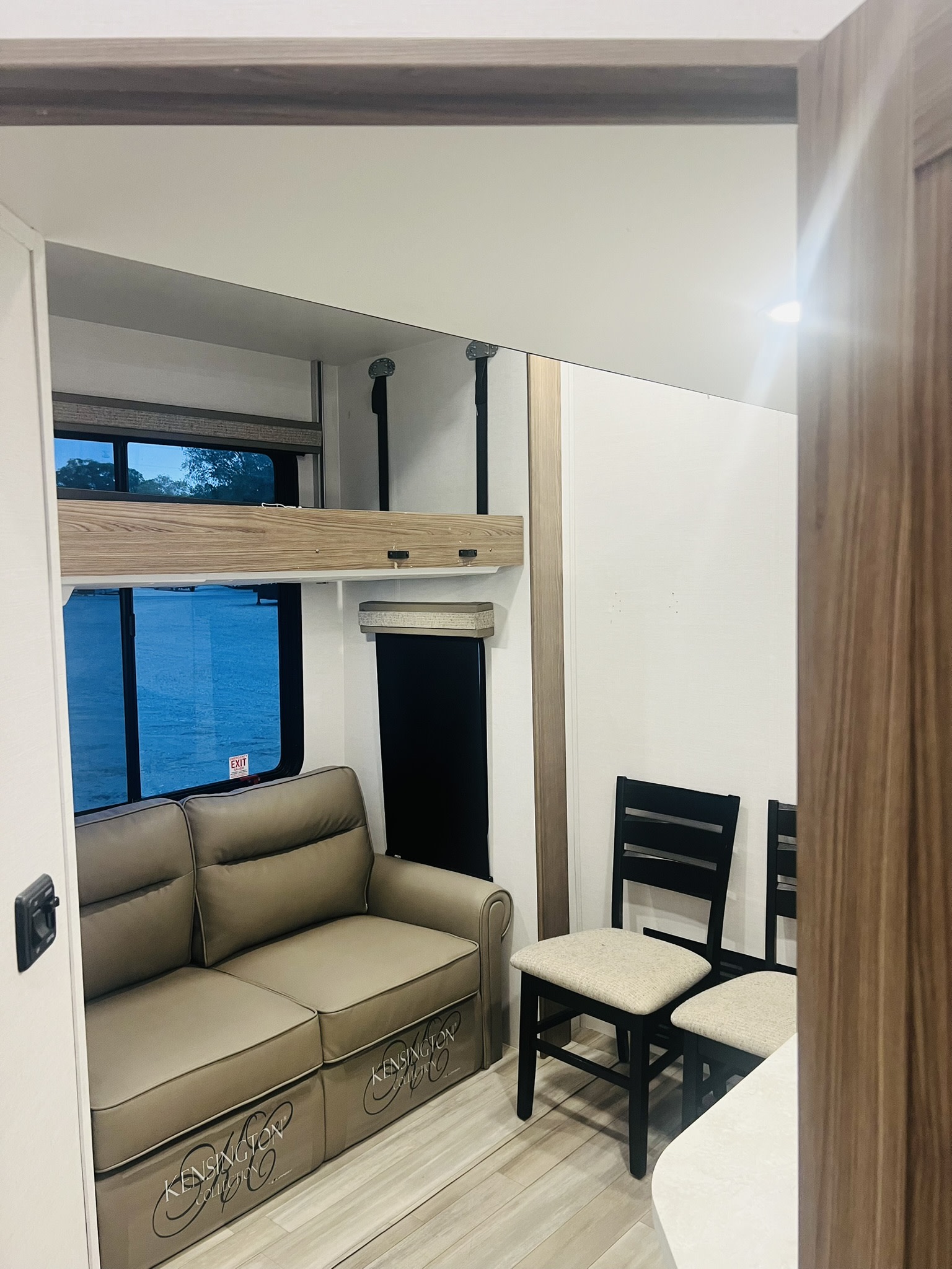 RV rental living area: Comfortable sofa, bunk bed, and dining chairs for your road trip comfort in this modern camper interior.. Alliance RV Paradigm 2024