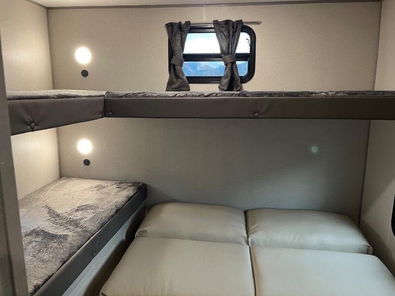 Experience comfort in your RV rental with these functional bunk beds and extra sleeping space.. Forest River Catalina Coachmen Legacy 293QBCK 2026