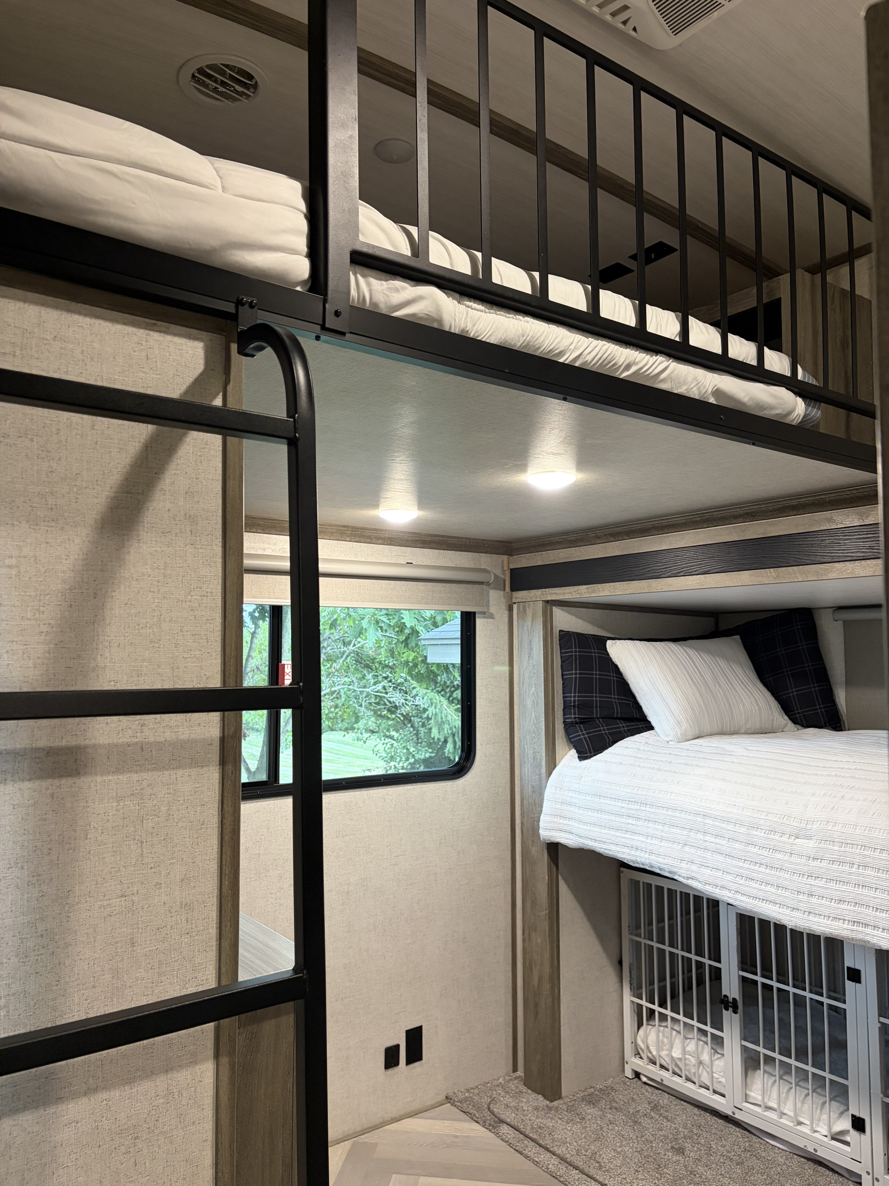 This cozy rv rental features multi-level bunk beds, a ladder for access, and a pet-friendly dog crate under the lower bunk.. Forest River Salem Hemisphere 2021