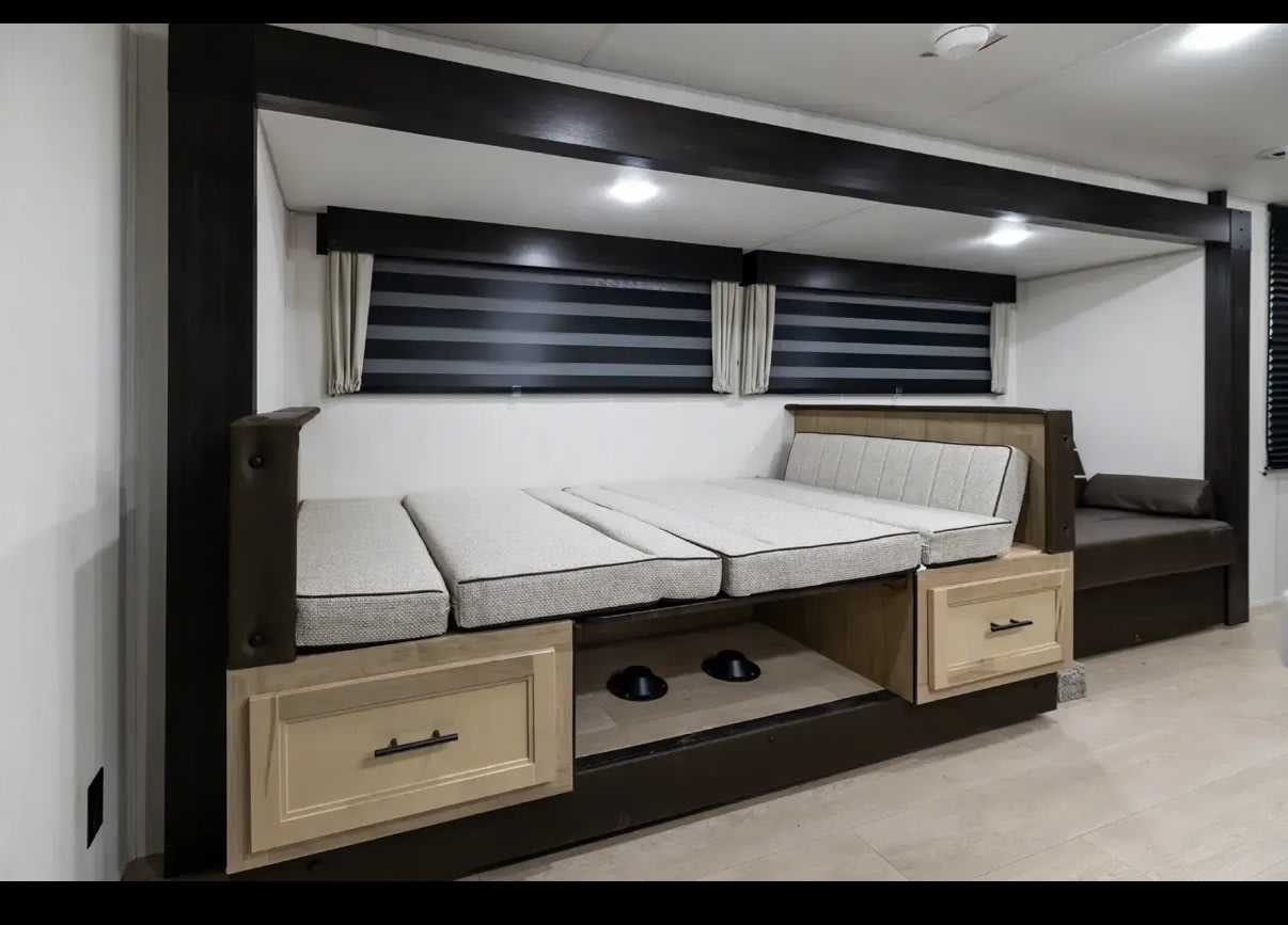 RV rental interior: modern bunk beds with storage, striped blinds, and recessed lighting for comfortable travels.. Forest River Cherokee Grey Wolf 2026