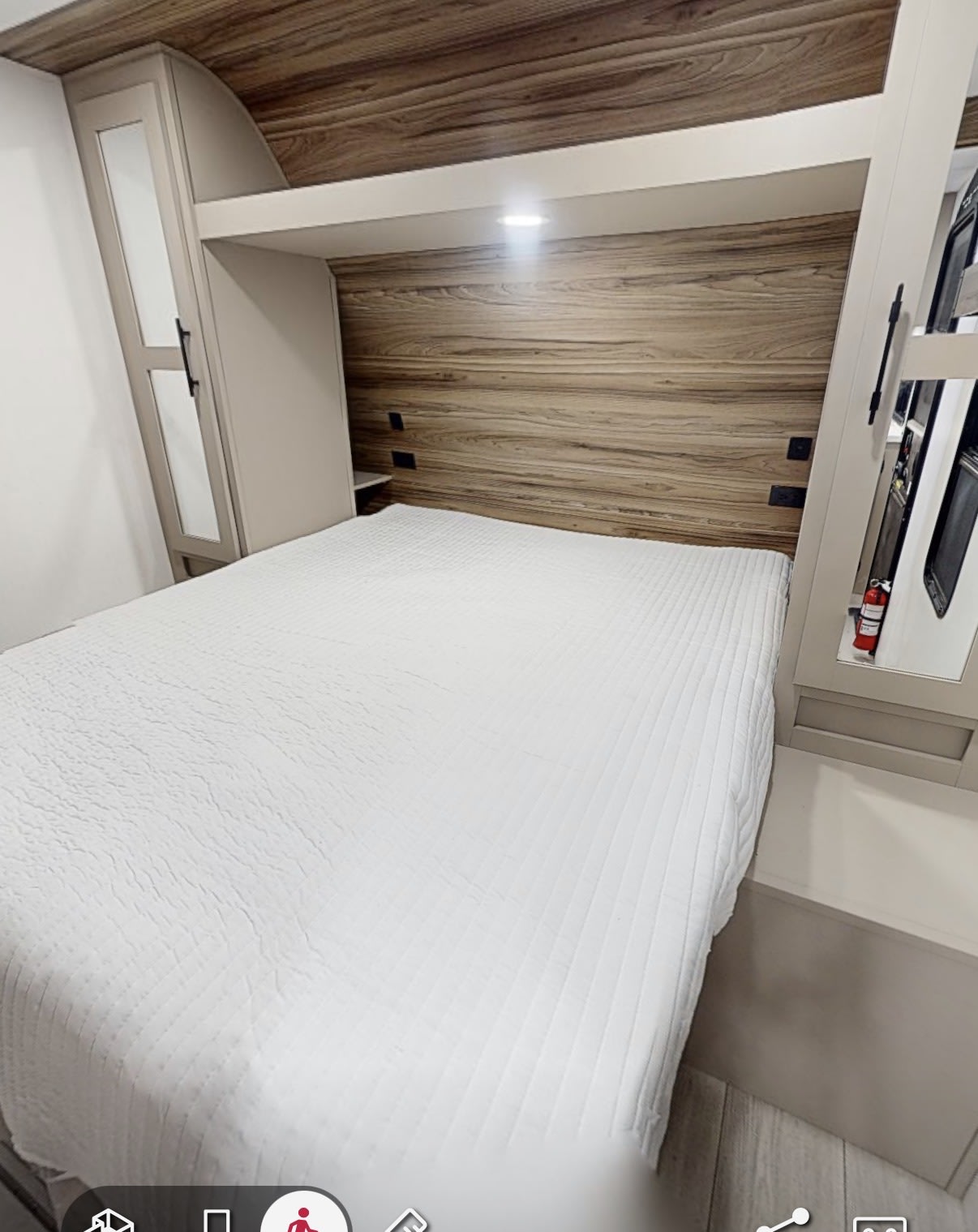 Cozy RV rental bedroom featuring a pristine white bed, stylish wood accents, overhead storage, and integrated lighting.. KZ Connect SE 2026