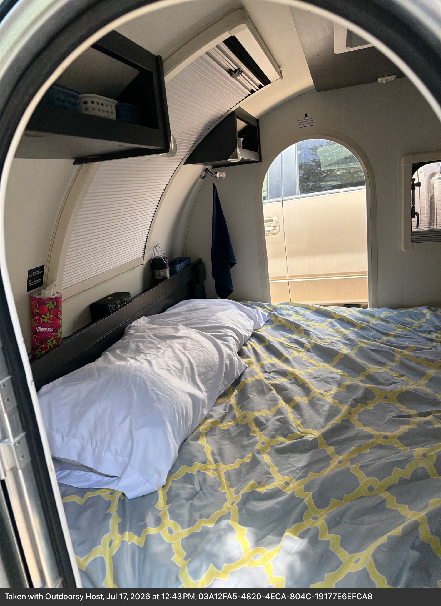 Cozy RV rental bedroom with a comfy patterned bed, storage, and blinds for a private, relaxing stay.. nuCamp T@G 2021