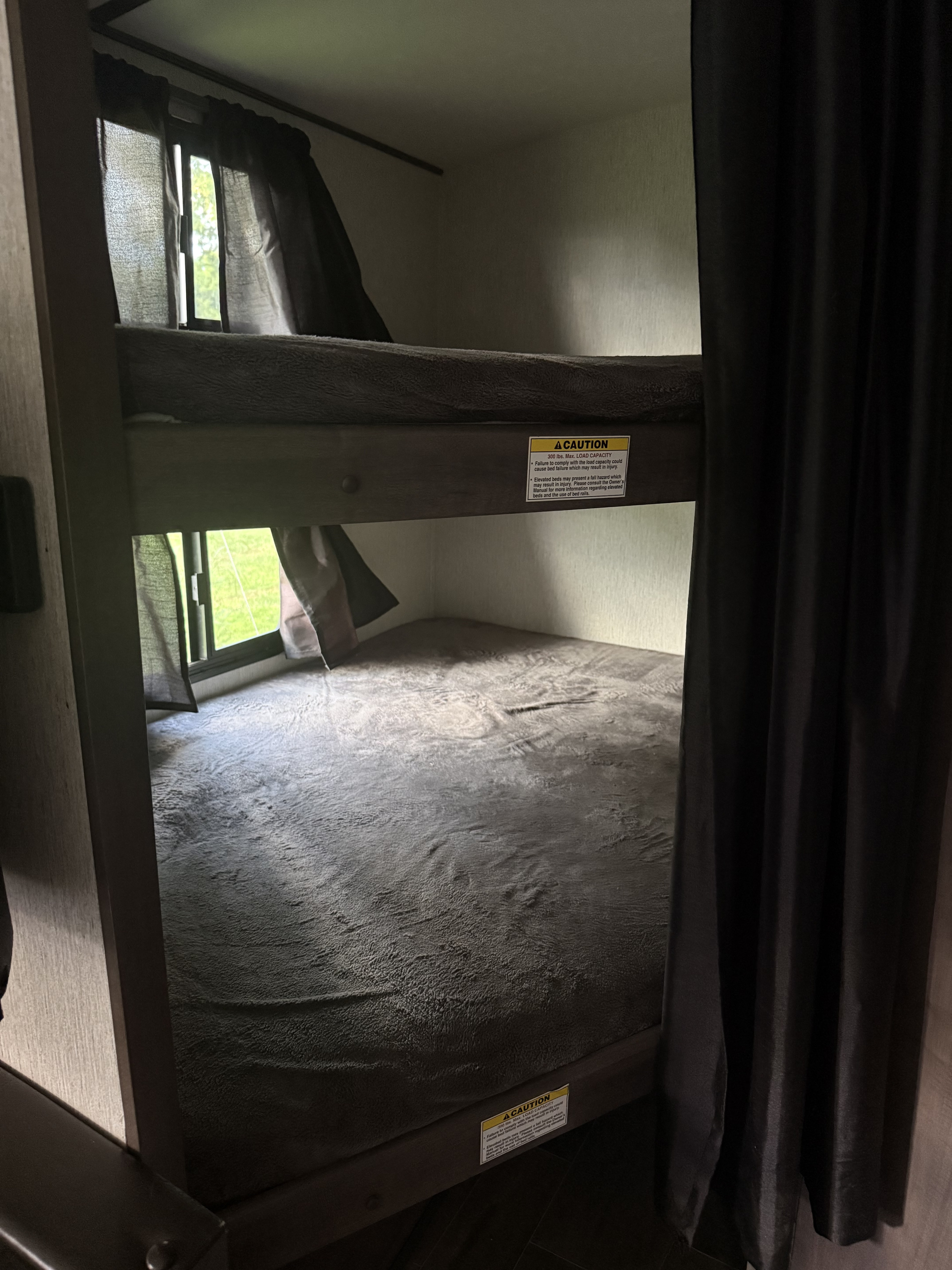 RV rental: Bunk beds with windows & privacy curtains. Safety labels warn of load capacity.. Crossroads RV Sunset Trail Super Lite 2019