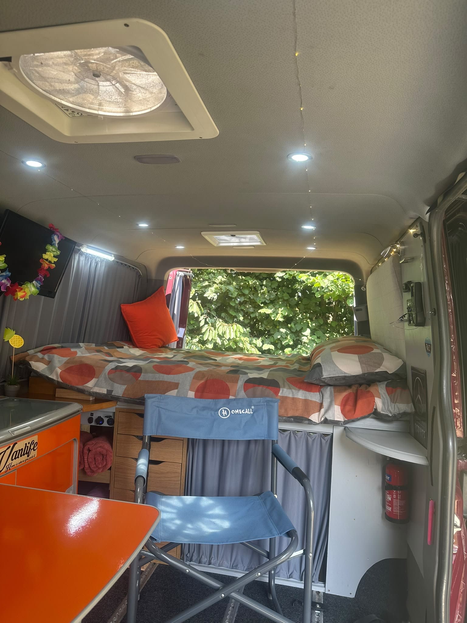 Cozy camper van interior for your next RV rental adventure! Features a bed, table, fan & storage. Perfect for vanlife.. Mercedes Sprinter 2014
