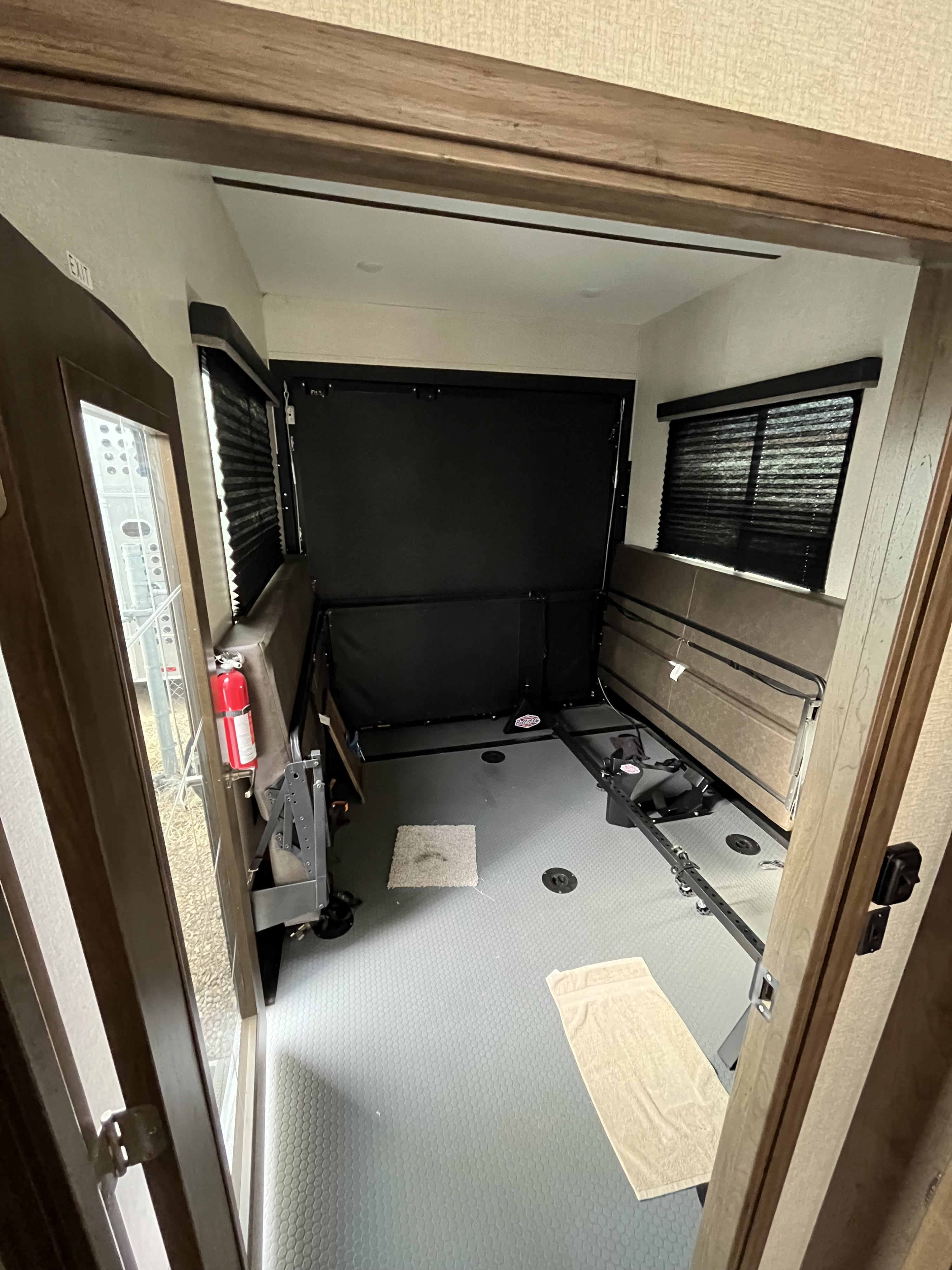 RV rental's versatile toy hauler garage with fold-down beds, durable textured floor, and large windows.. Keystone RV Cougar Toy Hauler 2020