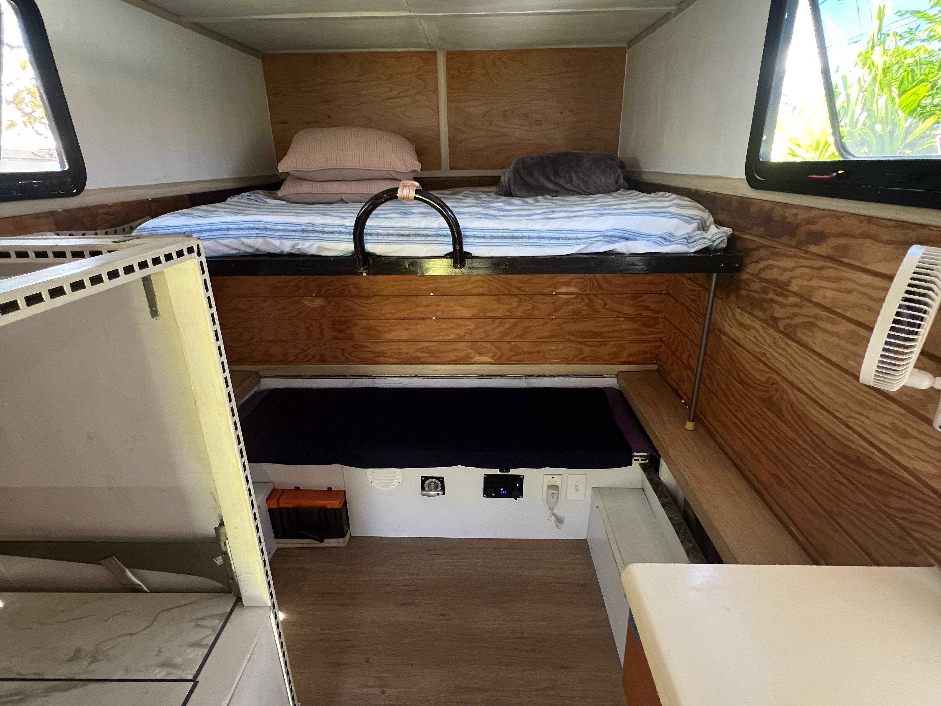 Cozy RV rental interior featuring bunk beds, wooden paneling, and accessible power outlets for a comfortable stay.. Ford Ford F150 2019