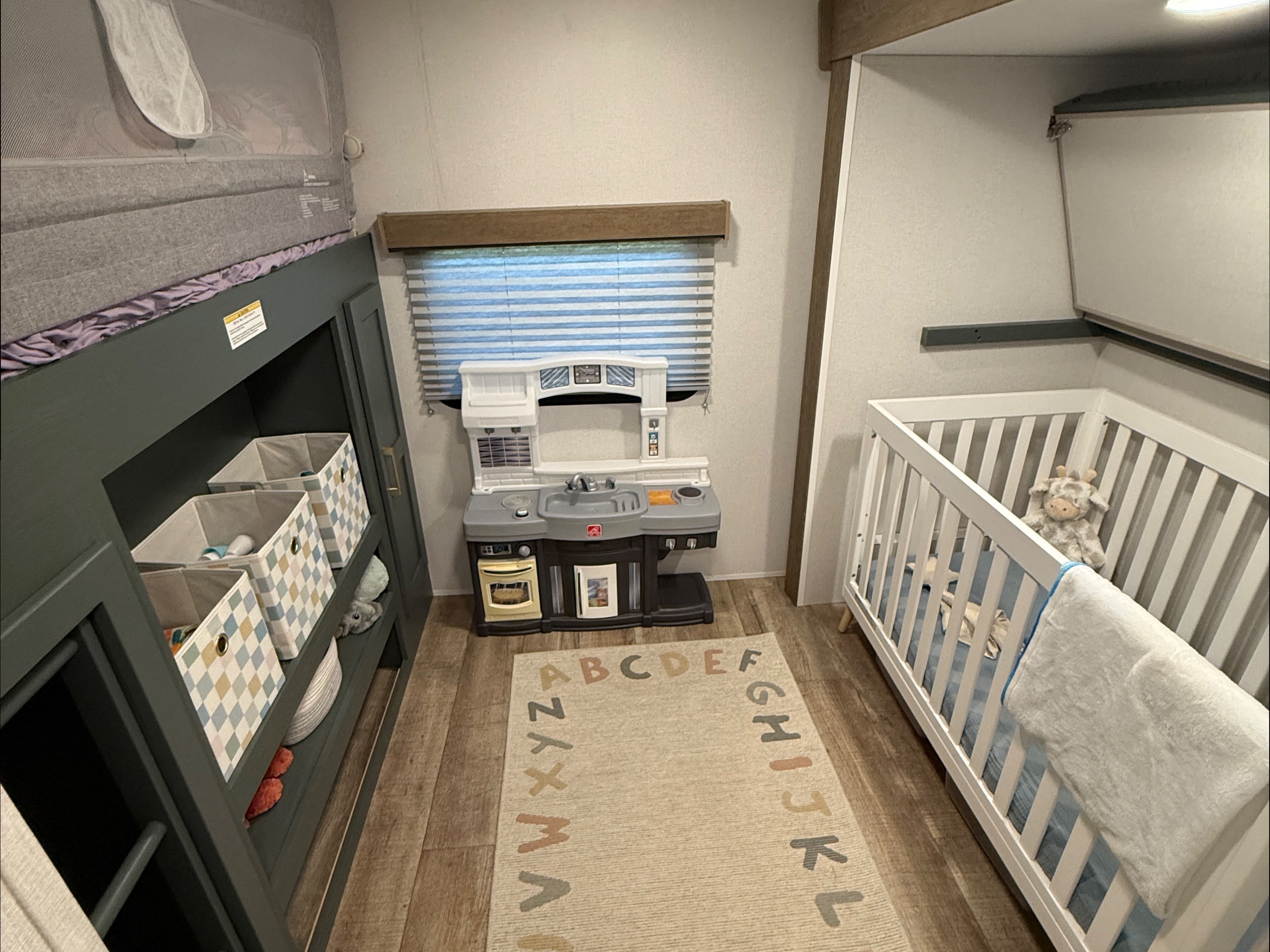This RV rental features a cozy kids' area with a bunk bed, play kitchen, and baby crib, perfect for family adventures.. Heartland RVs Eddie Bauer 2026