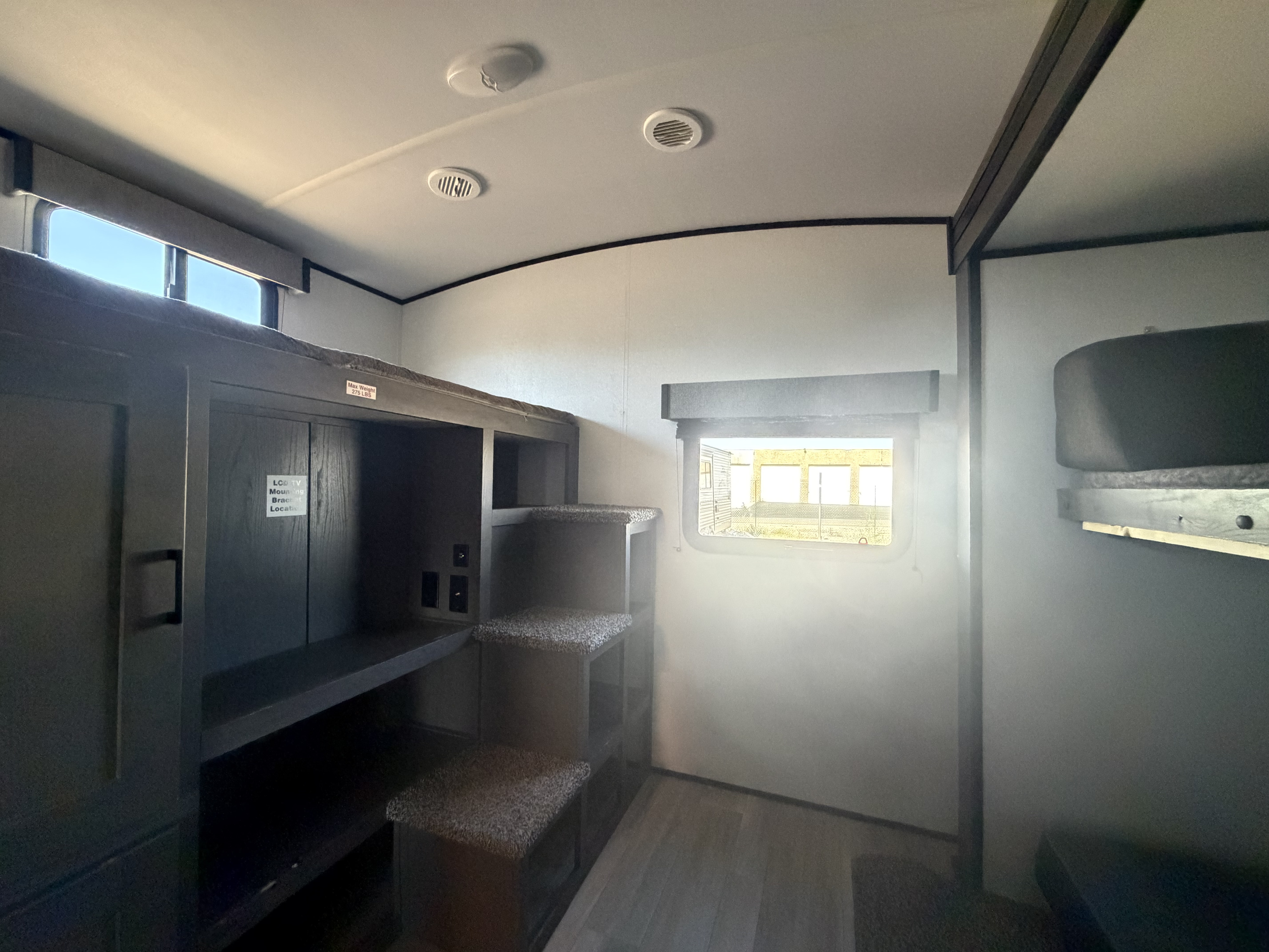 RV rental interior: bunk beds with carpeted steps, storage, power outlets, window, and overhead vents, providing compact comfort.. Cruiser RV MPG Ultra Lite 2021