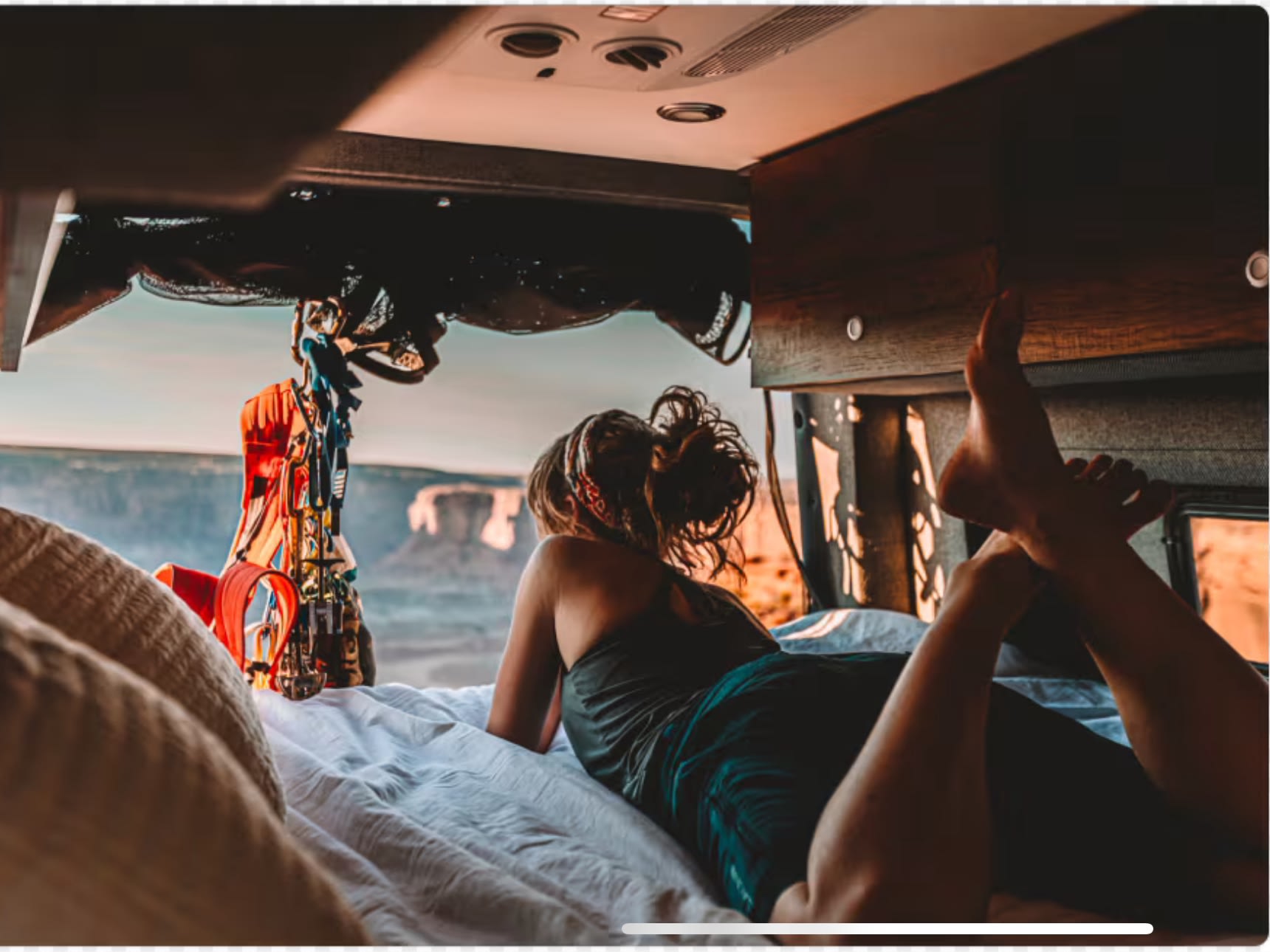 A person enjoys a breathtaking desert view from a cozy rv rental bed. The perfect setup for van life road trips.. Storyteller Overland Beast MODE 4x4 2023