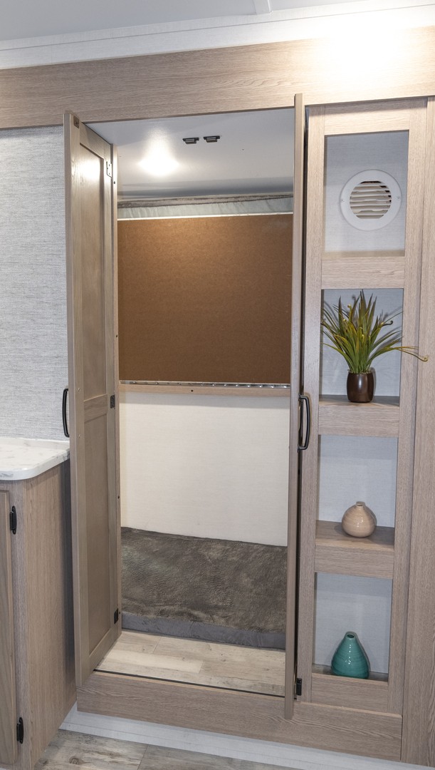 RV rental interior: Open closet/storage with light wood cabinetry, decor & a modern design, offering functional space.. Gulf Stream Amerilite 2026