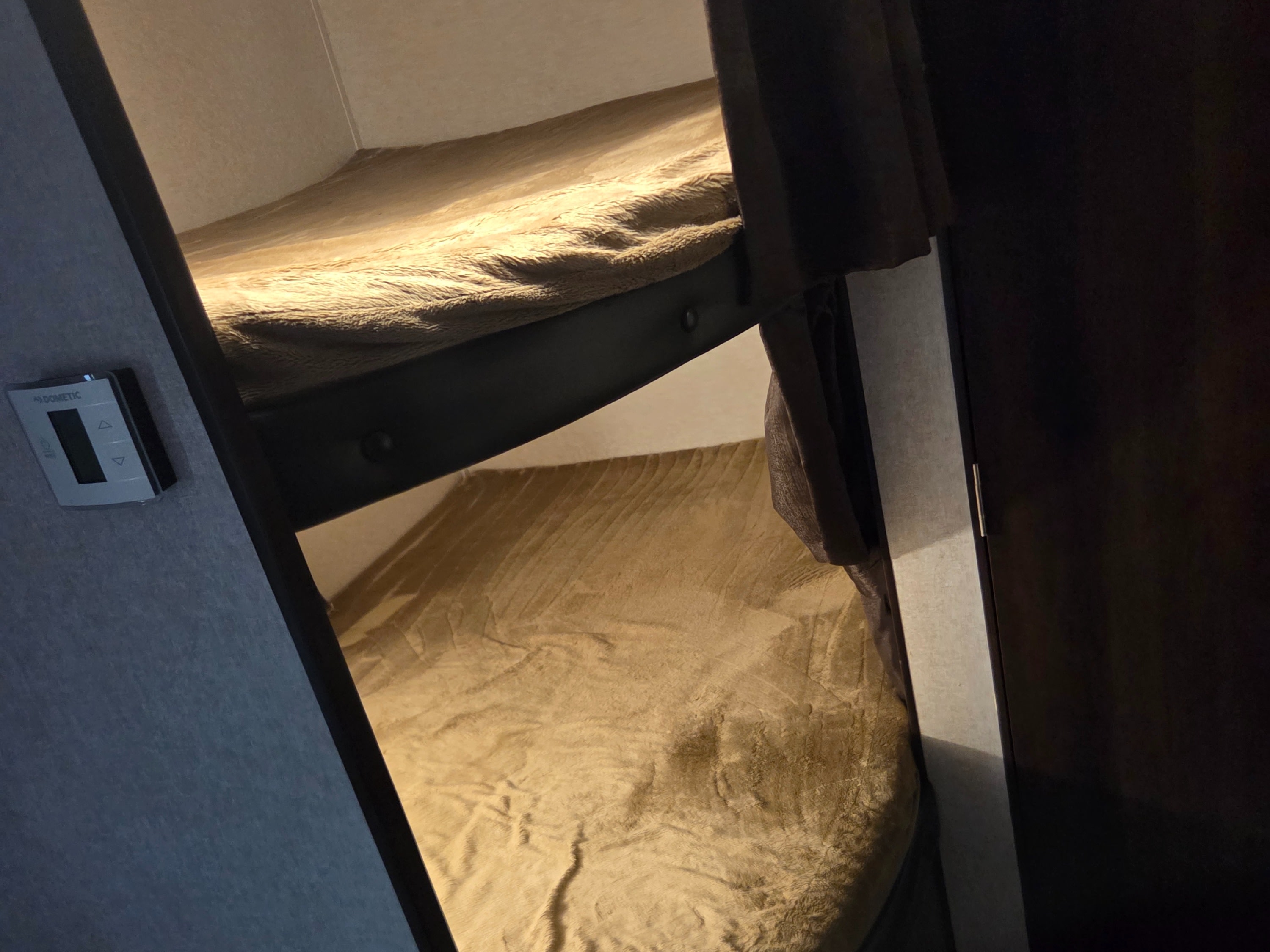 Cozy RV rental bunk bed area with soft blankets and a Dometic control panel on the wall.. Jayco Jay Flight 2018