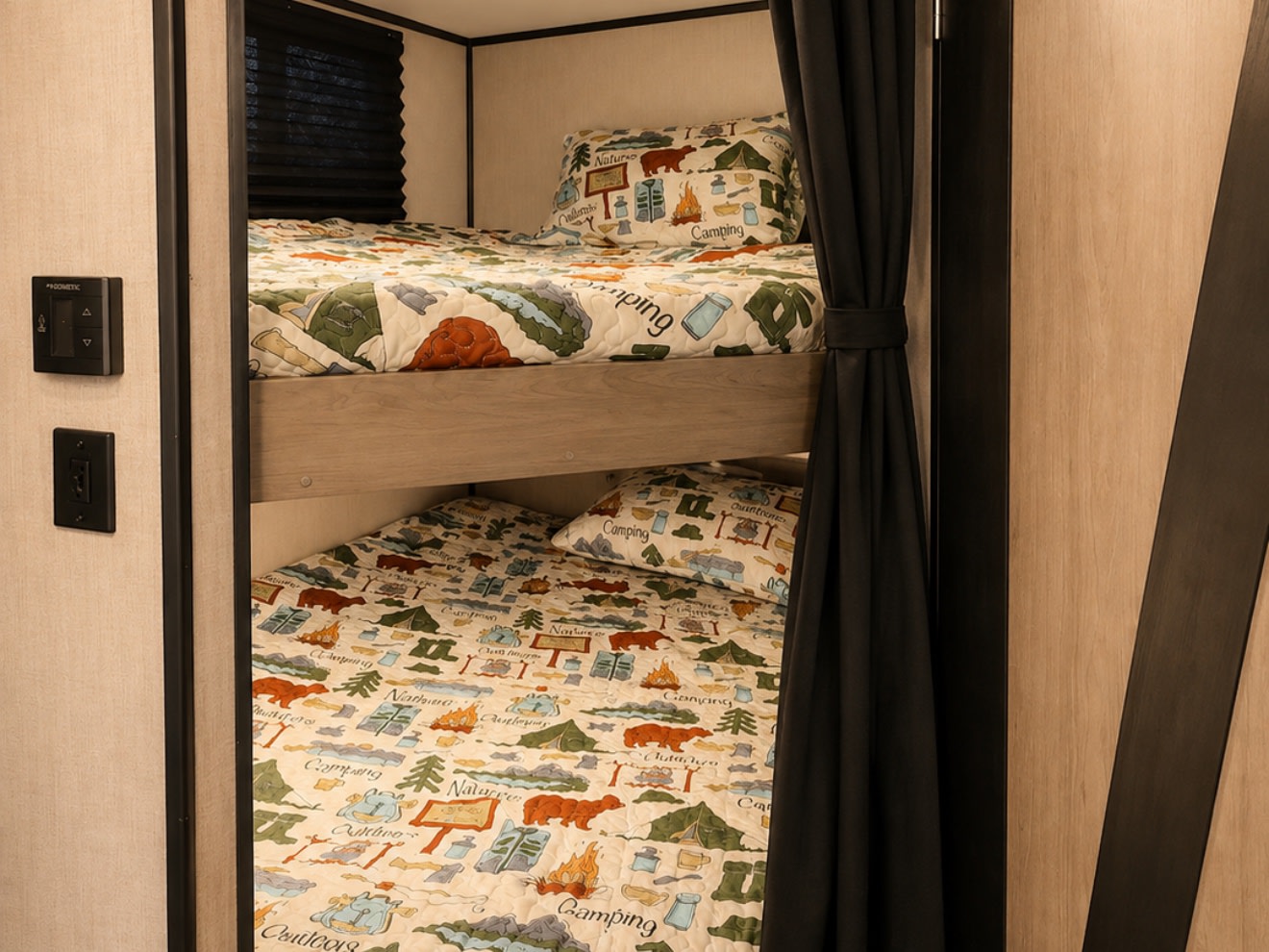 Cozy bunk beds with camping-themed bedding inside an RV rental, offering comfortable sleeping for your adventure.. Heartland RVs Mallard 2021
