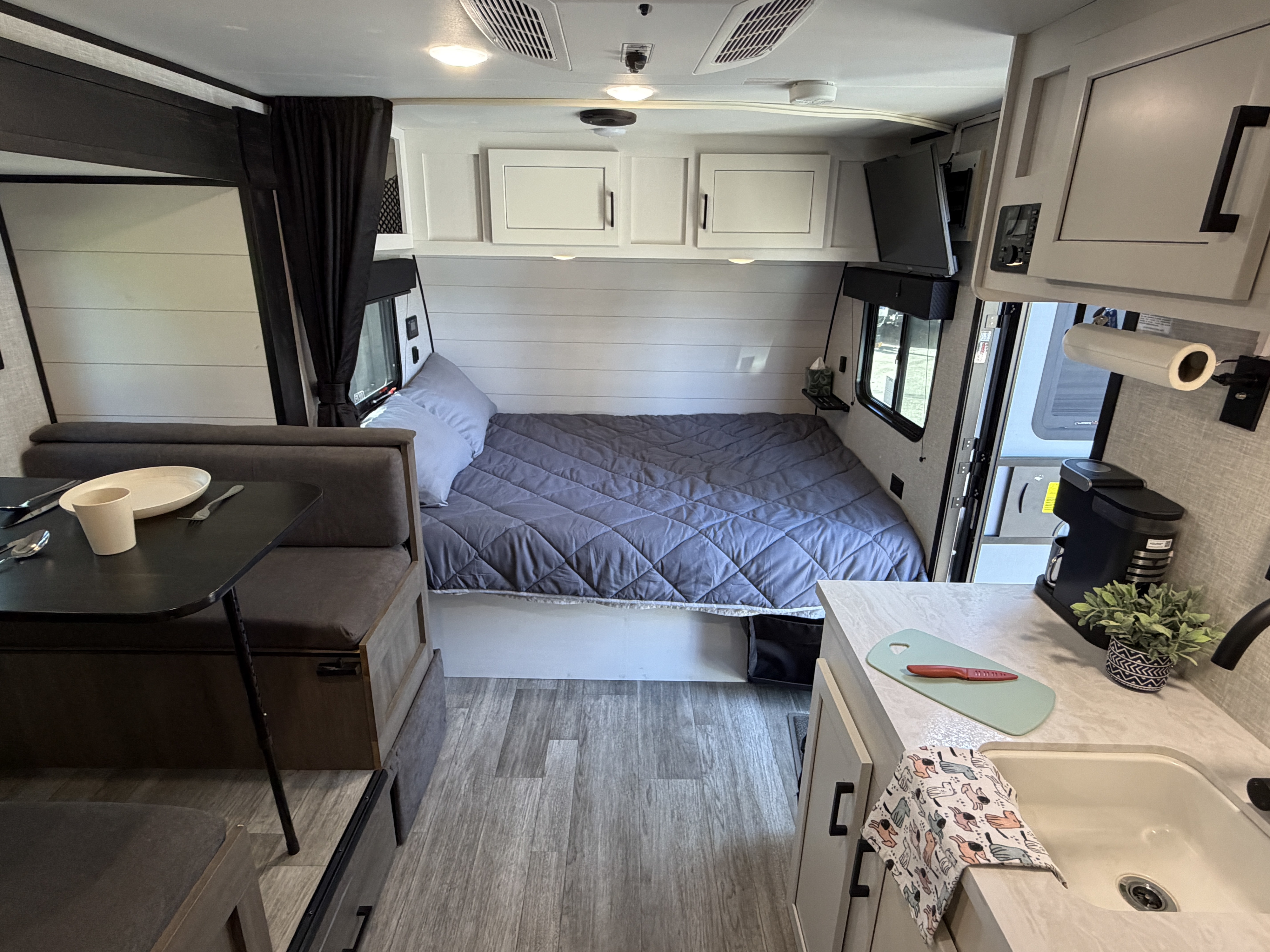 An inviting rv rental interior with a snug bed, dining space, and compact kitchen for comfortable adventures.. Jayco Jay Flight SLX Baja Edition 2024