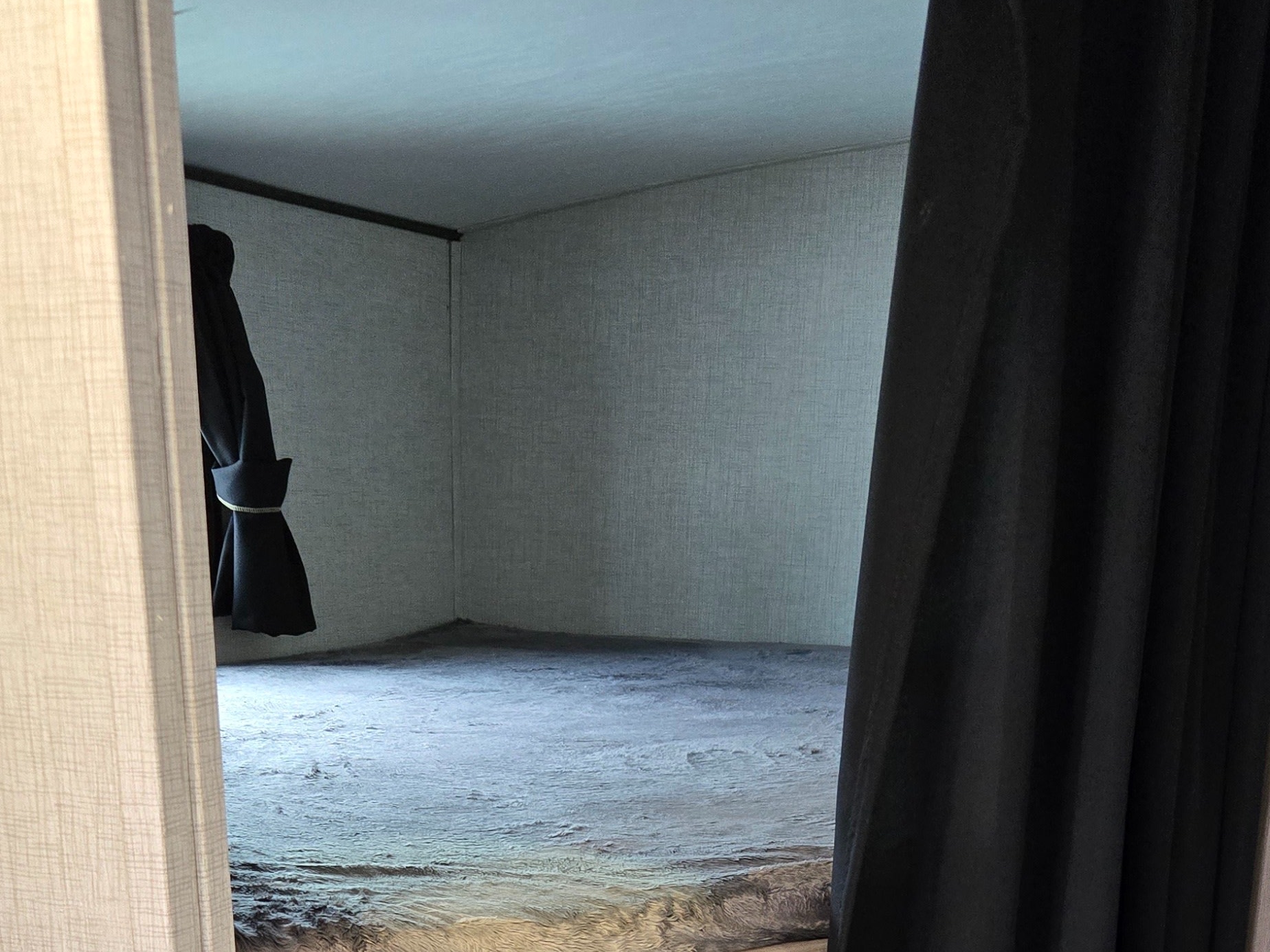 Inside an RV rental, showcasing cozy bunk beds with dark, fuzzy blankets and a privacy curtain to the right.. Crossroads RV Sunset Trail Super Lite 2022
