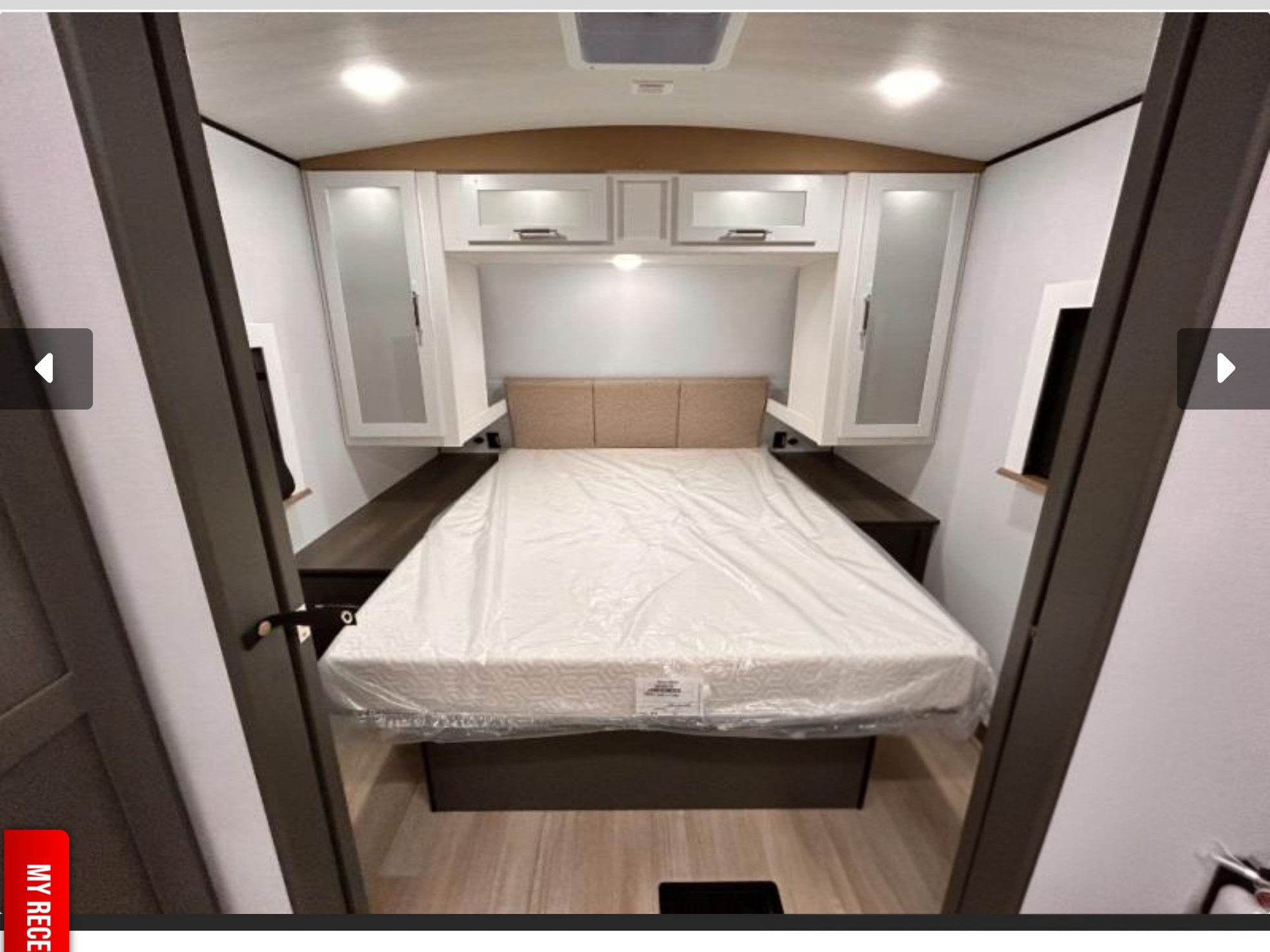 This modern RV rental bedroom features a new, comfortable bed, overhead storage, and soft lighting for cozy nights.. Keystone Bullet Crossfire 290BHSWE 2027