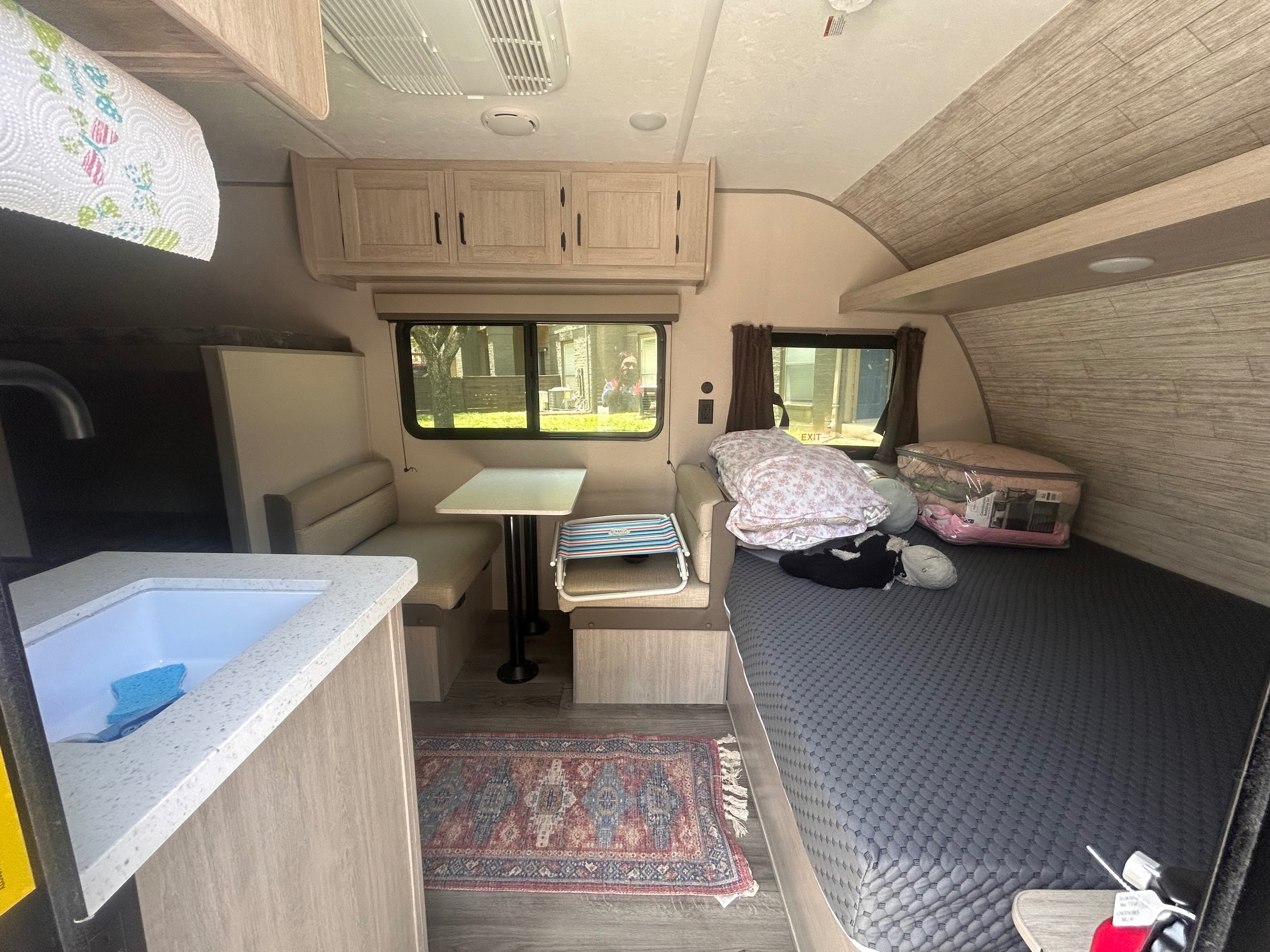 Explore this compact RV rental interior: kitchen sink, dinette, and comfy bed area.. Coachmen Catalina Summit Series 7 2026