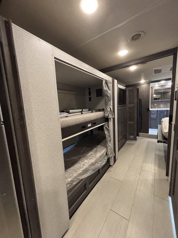 Spacious bunk beds in a modern RV rental, perfect for family travel or camping adventures.. Thor Palazzo 2023