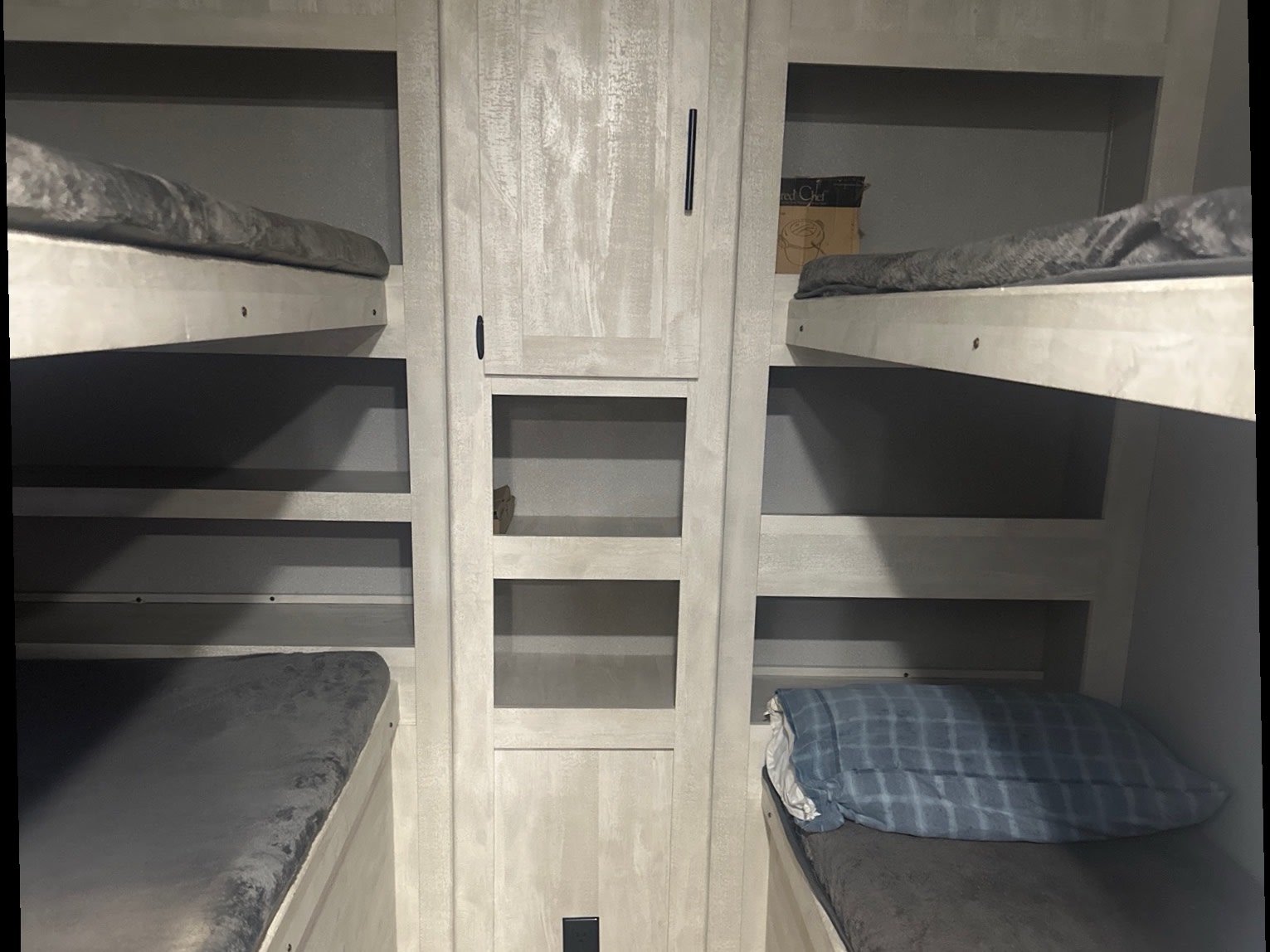 RV rental: Bunk beds, central storage with shelves & cabinet, offering practical sleeping and organization space.. Forest River Shasta 2022