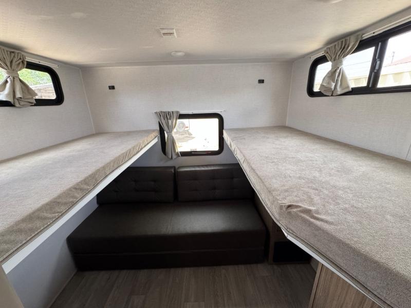 RV rental interior featuring comfortable bunk beds above a sofa, providing cozy sleeping and seating for your adventures.. Other Other 2027