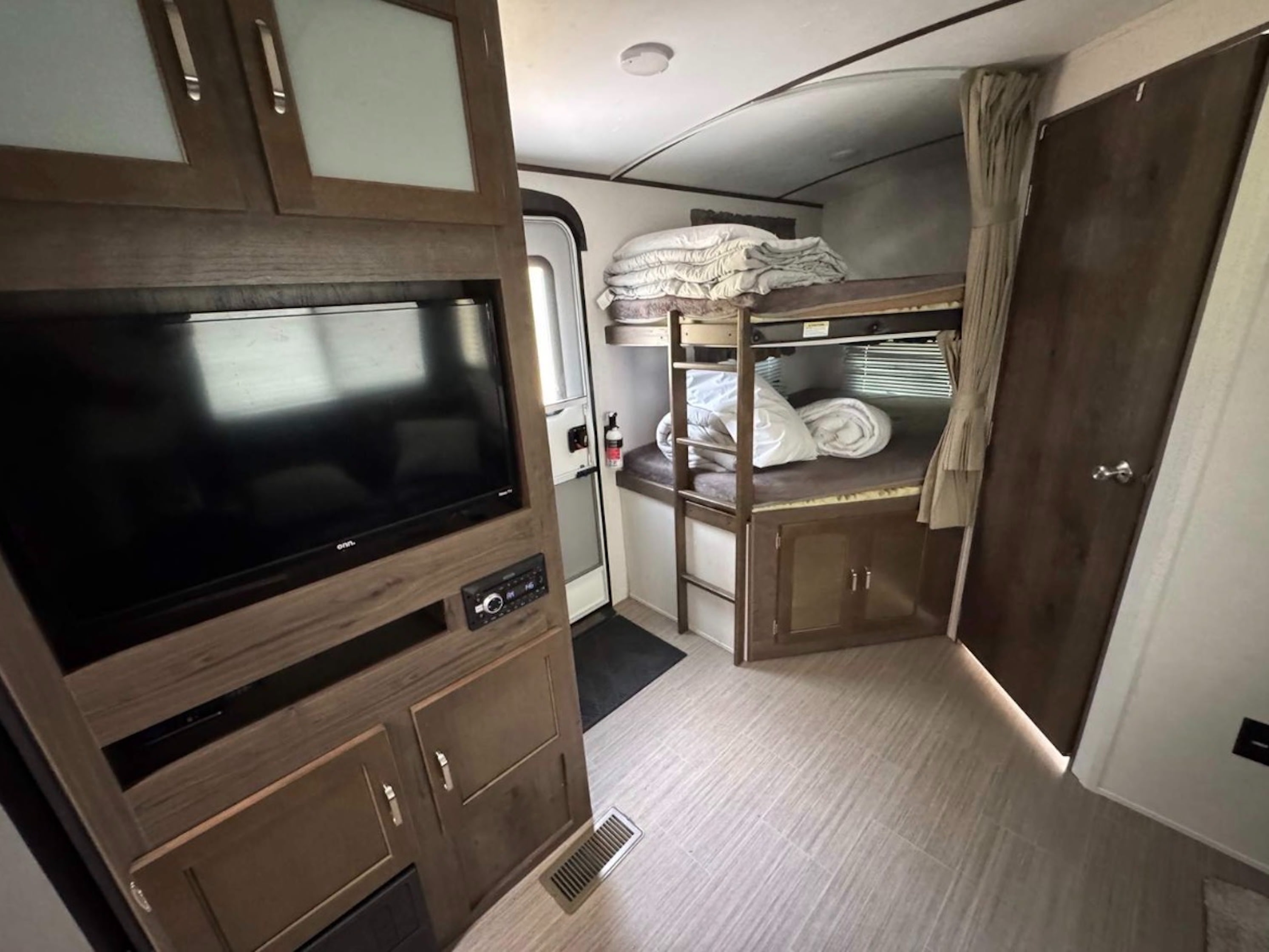 Inside this cozy RV rental, discover bunk beds for extra sleeping, an entertainment unit with a TV, and a full-size entrance door.. Keystone RV Passport Grand Touring 2019