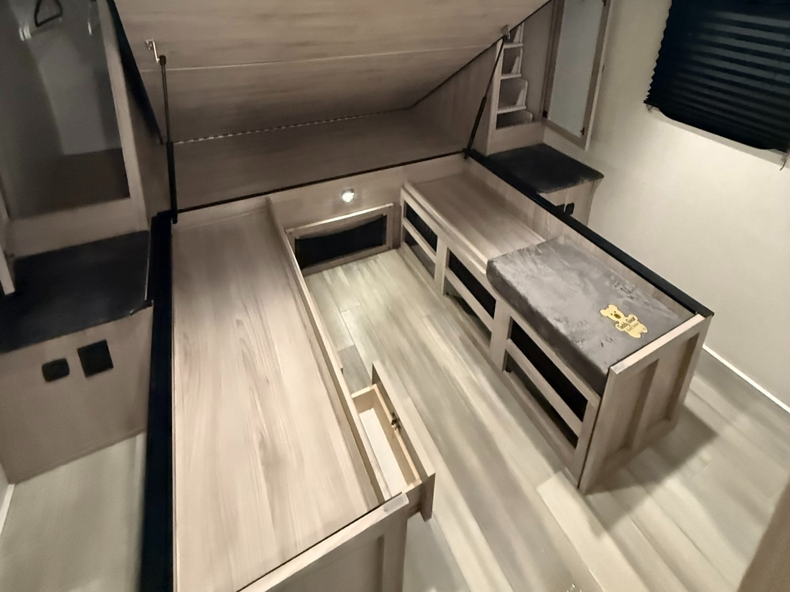 RV rental: Light wood bunk beds with gray cushions and built-in storage provide a practical sleeping area.. Coachmen Northern Spirit - 2557 RB 2023