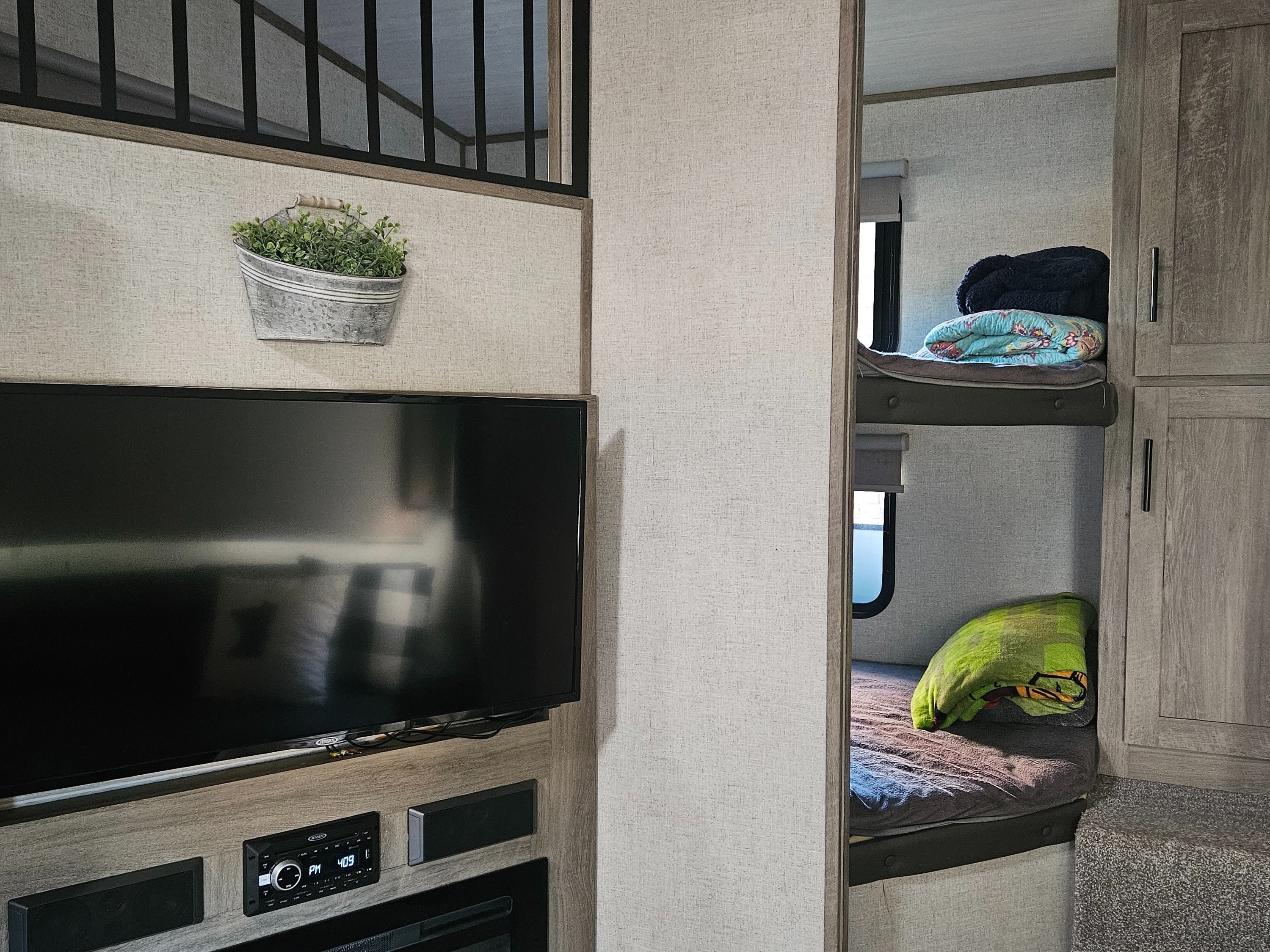 Inside a modern rv rental: TV, electric fireplace, cozy bunks, and loft area. Perfect for a family adventure.. Forest River Salem Hemisphere 2021