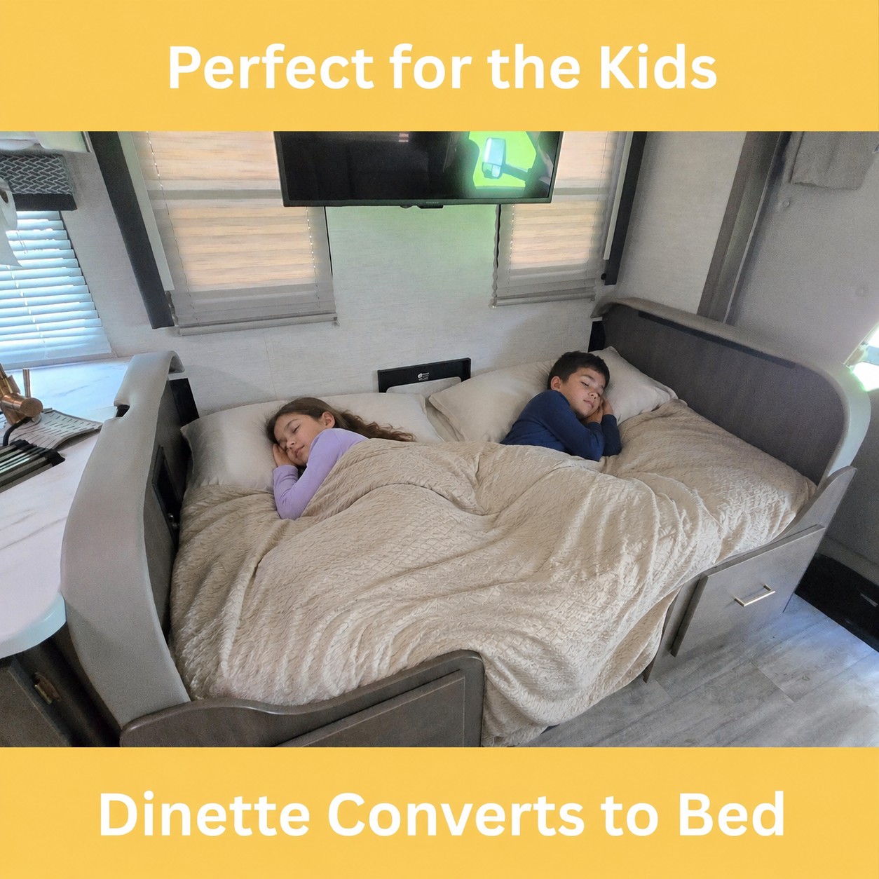 Perfect for RV rental trips! This dinette converts to a cozy bed for kids. Two children sleep soundly under a blanket.. Thor Four Winds 2024