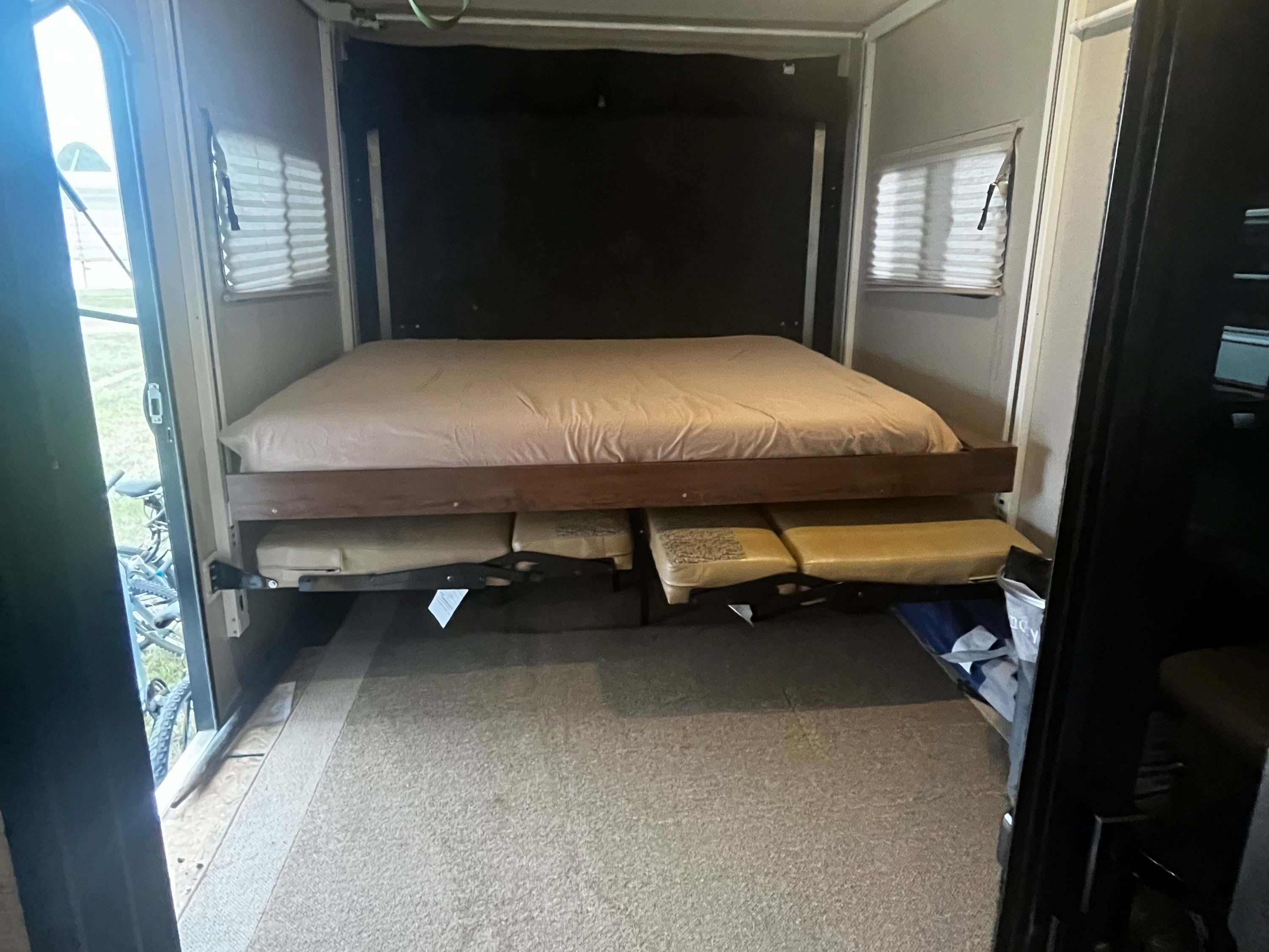 Inside this RV rental: a modular bed system with an upper bunk and lower cushions, offering flexible sleeping/lounge space.. Coachmen Freedom Express 2017