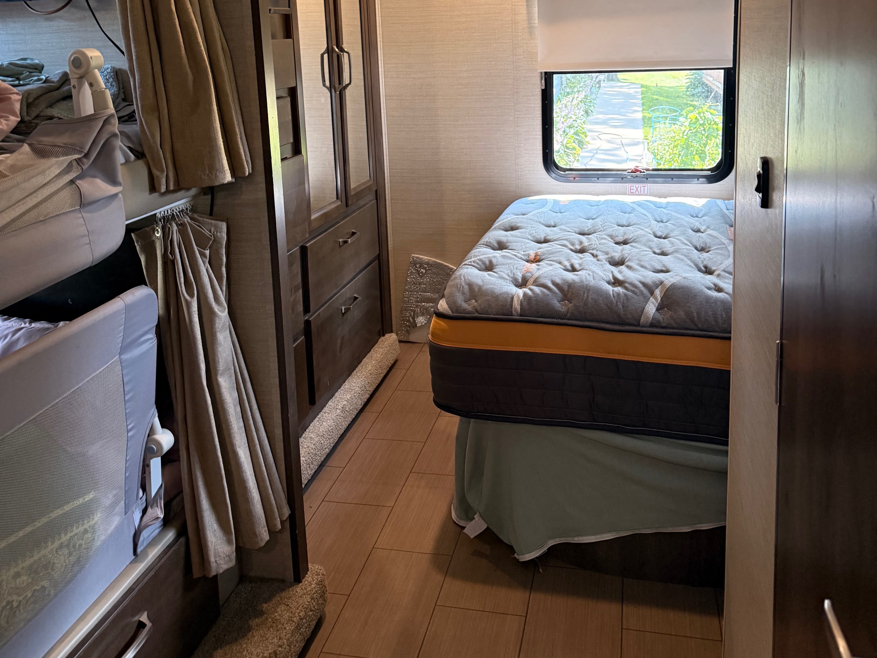 Cozy RV rental bedroom with a comfortable bed, wardrobe, window view, and modern finishes, perfect for travel.. Jayco Greyhawk Prestige 2019