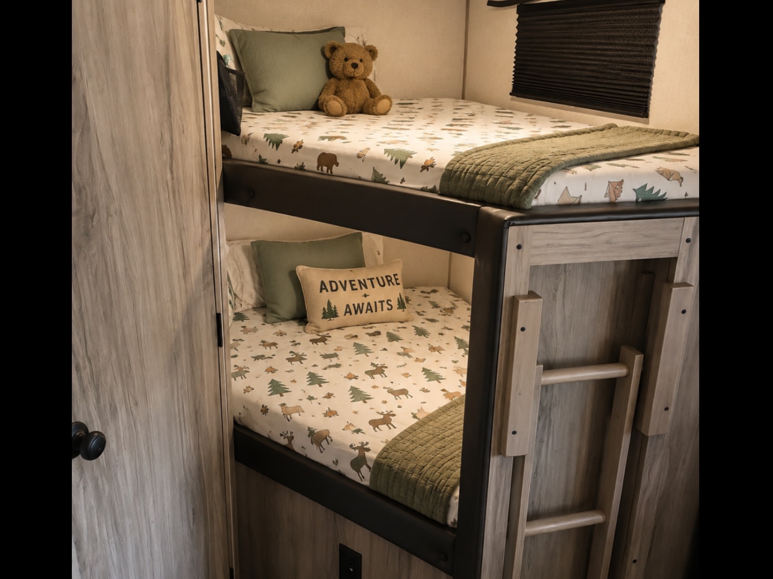 Cozy RV rental bunk beds with an adventure theme, featuring wood-look panels and a folding ladder, perfect for families.. Forest River Cherokee Alpha Wolf 2021