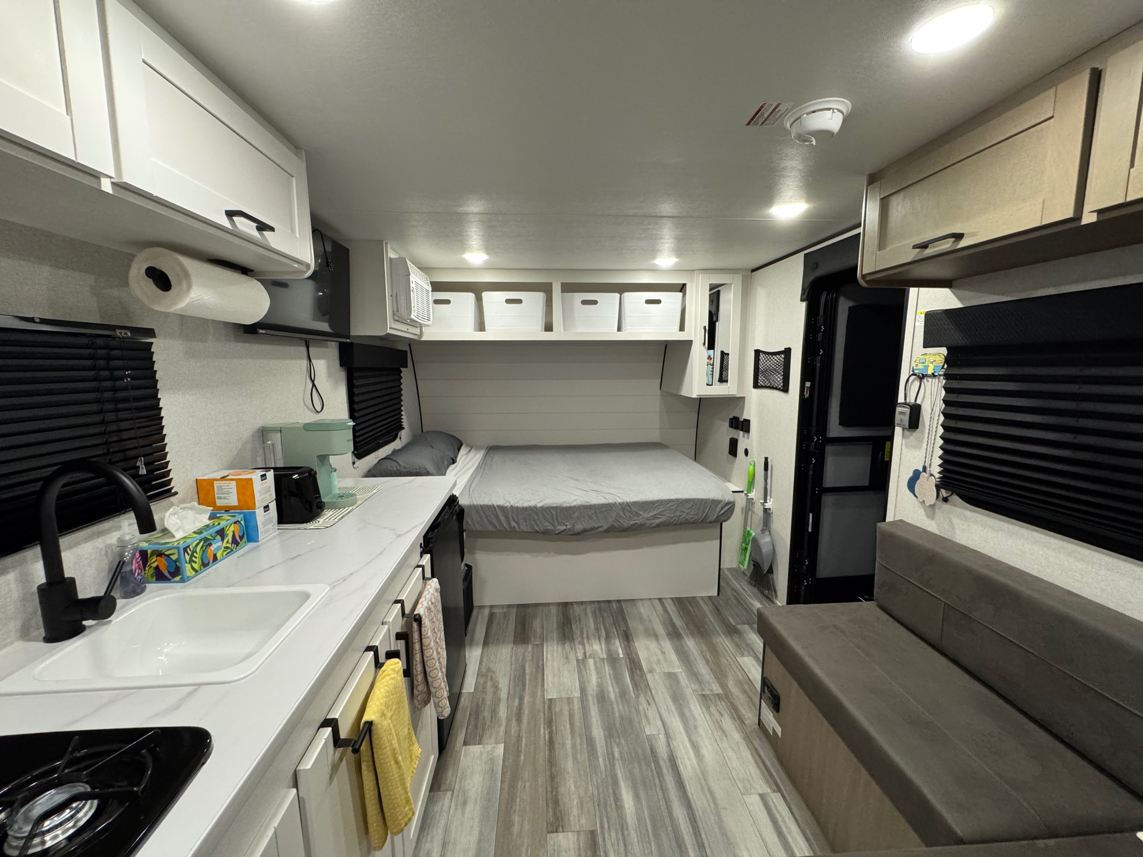 Step inside this cozy rv rental, showcasing a modern compact kitchen, comfortable bed with storage, and a small living space.. Jayco Jay Flight SLX Sport Edition 2026