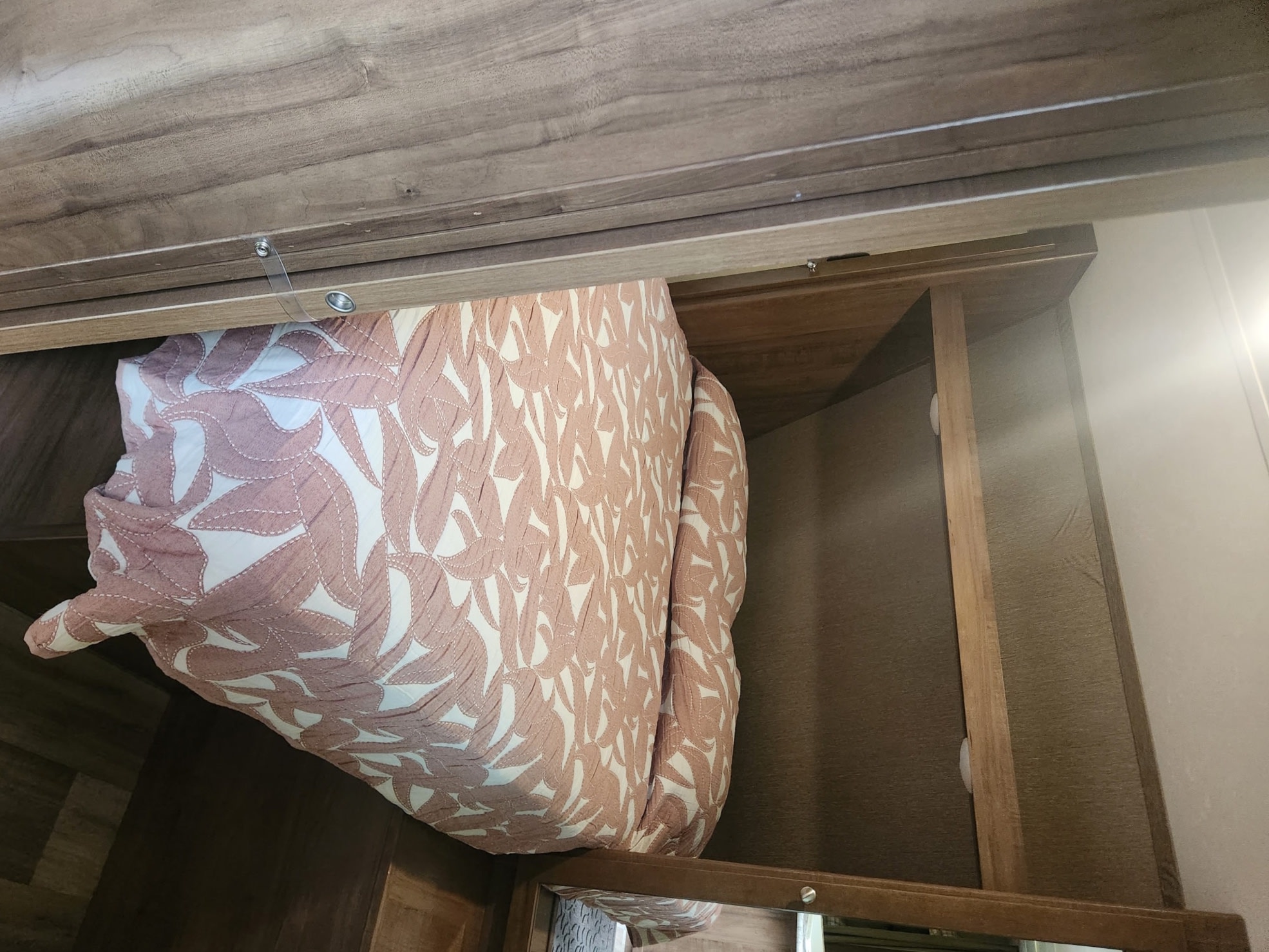 RV rental: Efficient overhead storage featuring a neatly tucked pink patterned cushion, showcasing practical space in a compact interior.. Aspen Trail Aspen Trail Trailer 2018