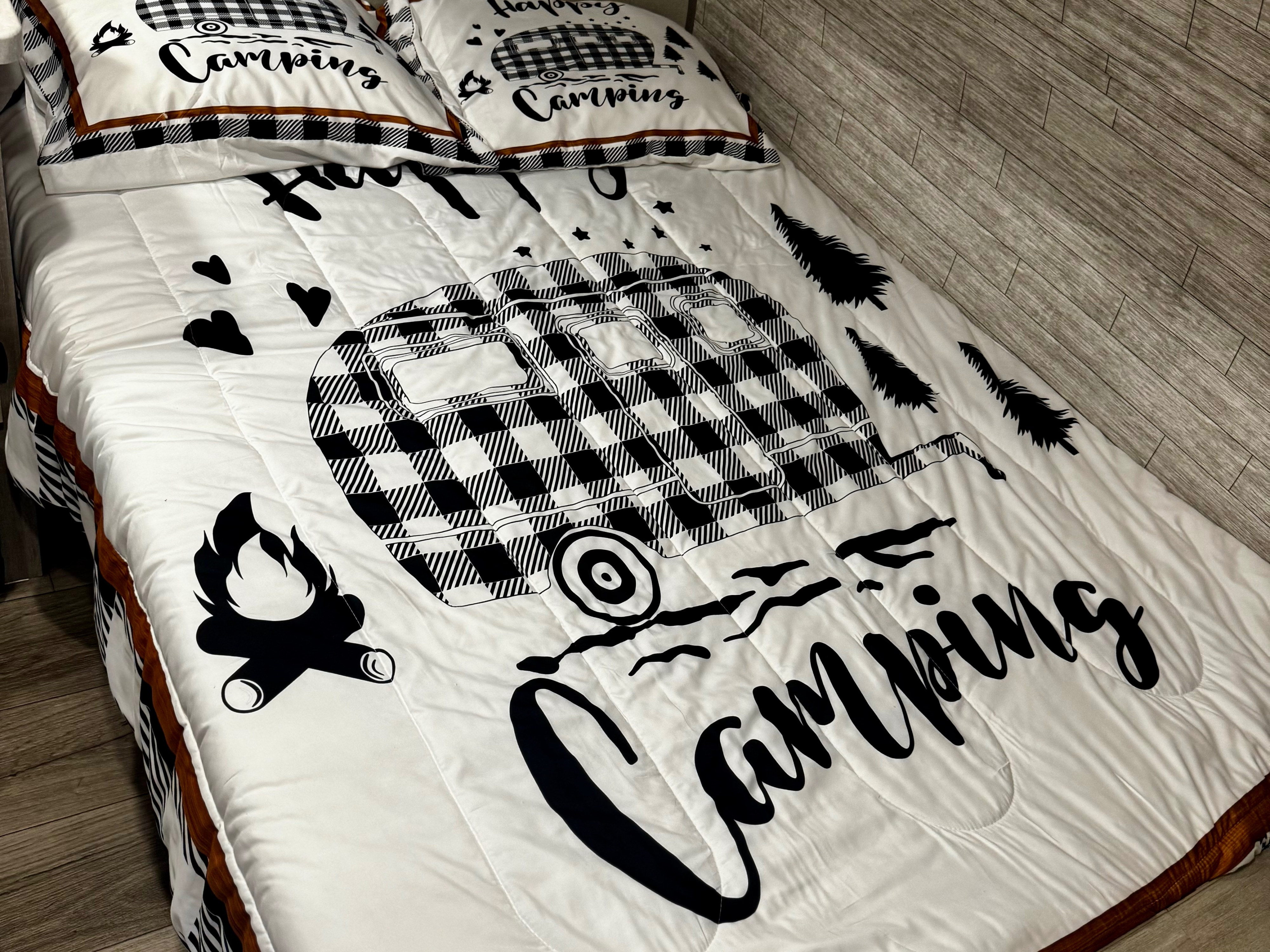 Cozy white camping bedding features a black plaid RV design and 'Camping' text, perfect for an RV rental. Pillows match.. Coachmen Catalina Summit Series 134BHX 2025