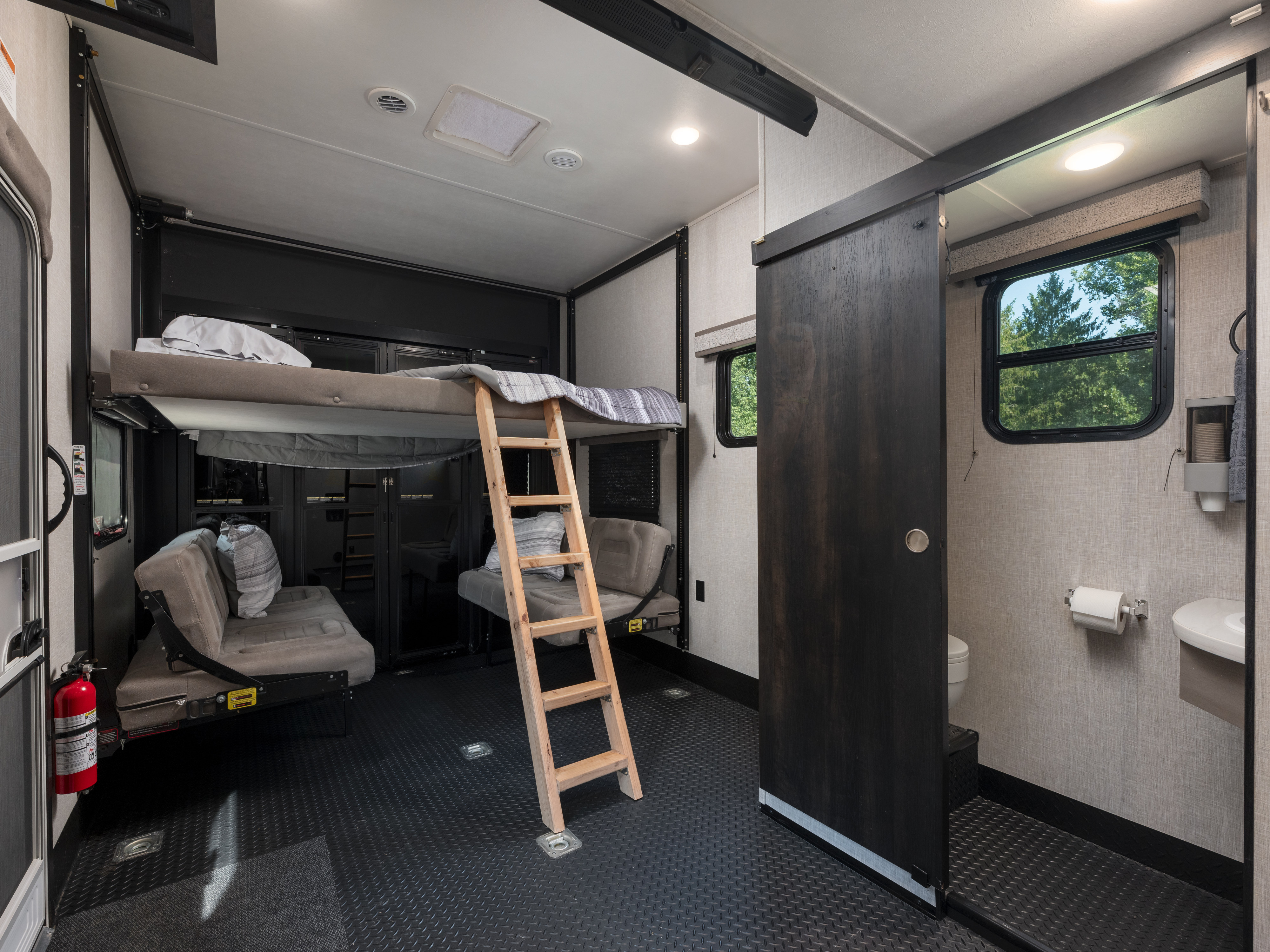 This rv rental's versatile interior features adjustable bunk beds, convertible seating, a bathroom, and durable flooring.. Jayco Seismic Luxury Toy Hauler 2024