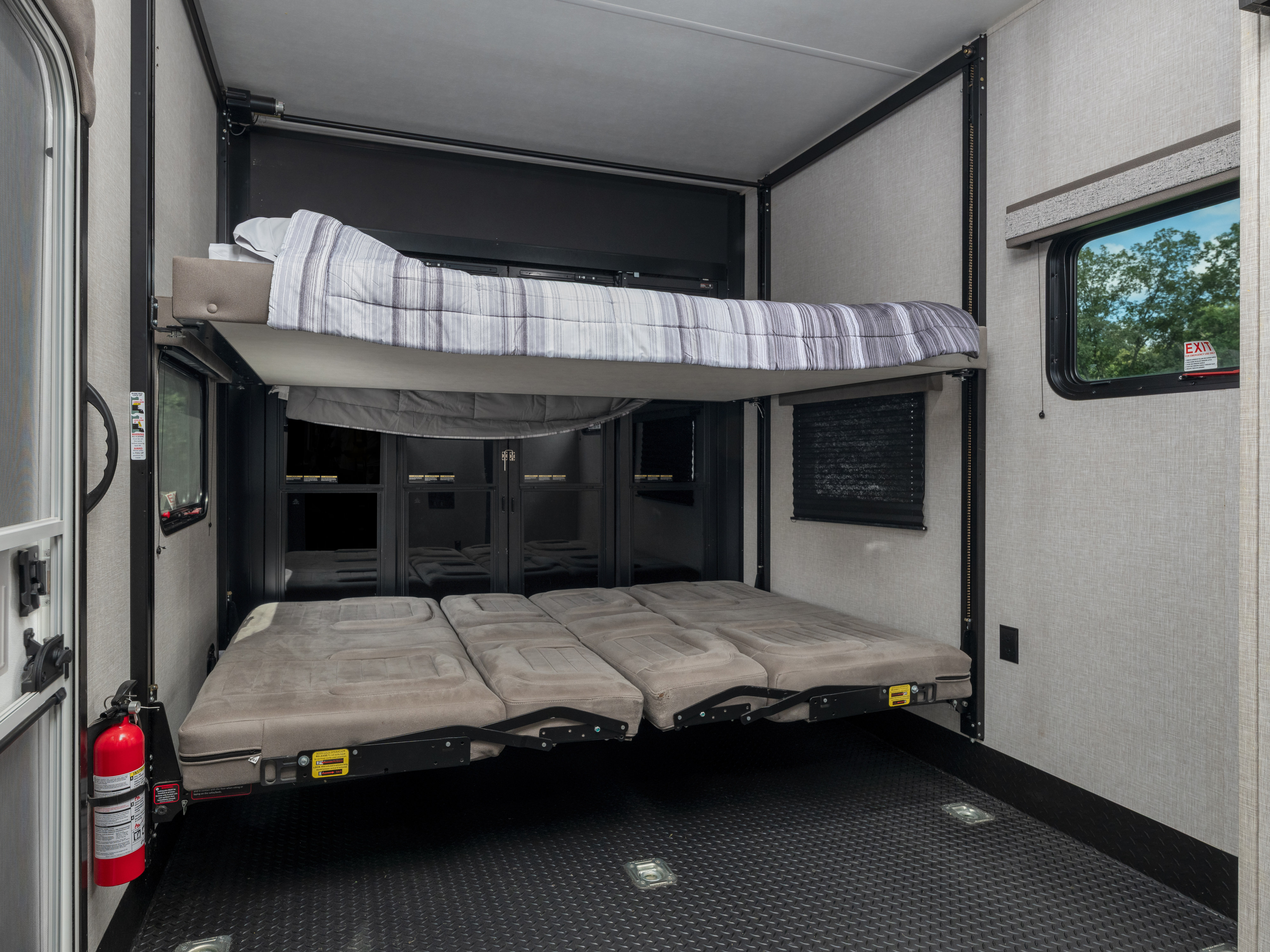 This RV rental toy hauler features adjustable bunk beds and convertible seating in a versatile garage space.. Jayco Seismic Luxury 5th Wheel 2024