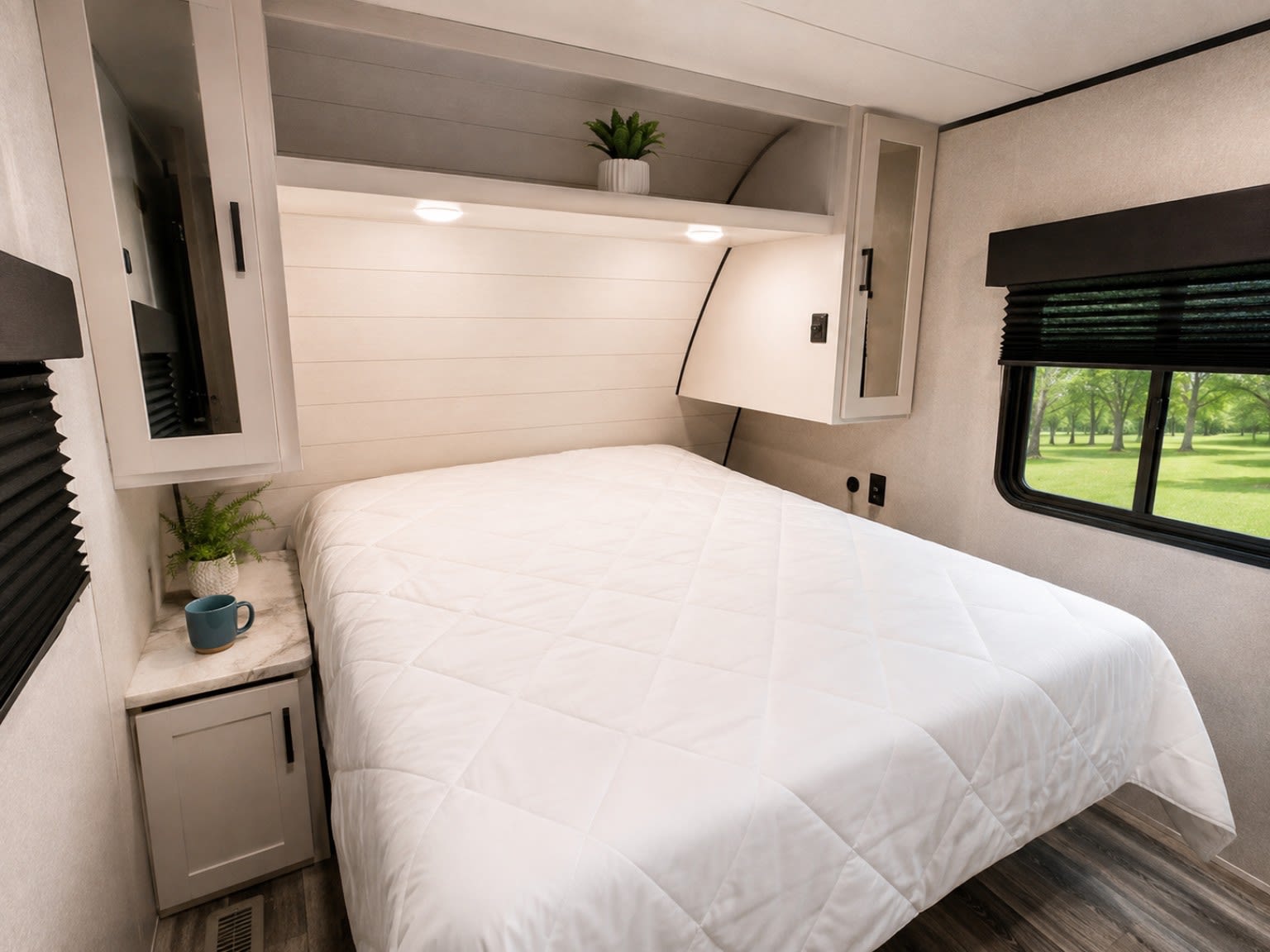 Cozy RV rental bedroom with comfortable bed, overhead storage, and a scenic window view for your next adventure.. Jayco Jay Flight SLX 2026
