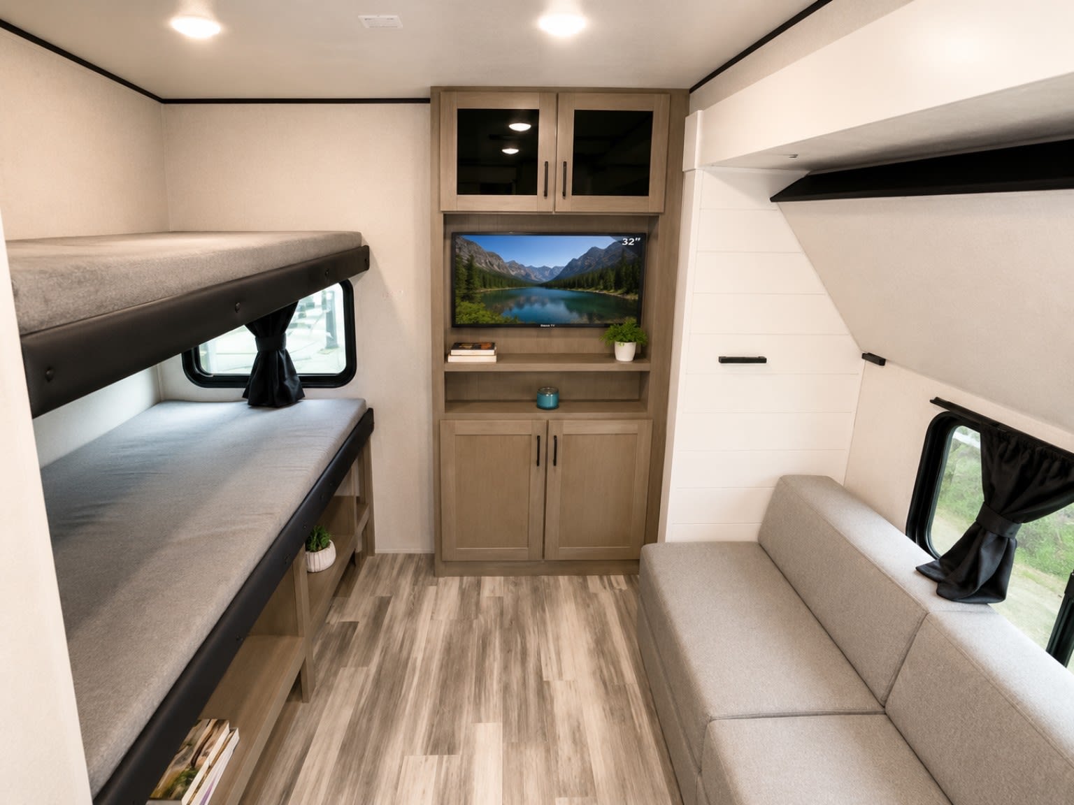 Comfortable RV rental interior featuring bunk beds, a sofa, and an entertainment center with TV. Ideal for family adventures.. Jayco Jay Flight SLX 2026
