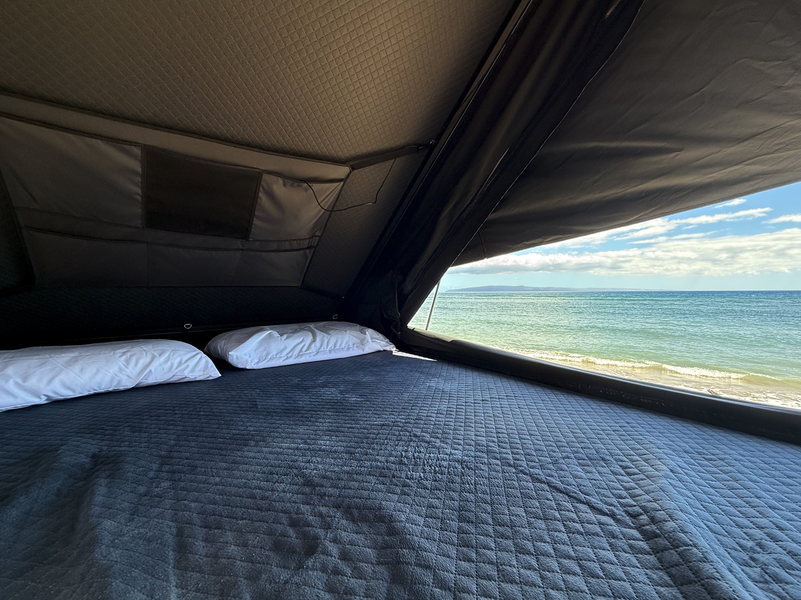 Cozy rv rental bed with stunning ocean views from a rooftop tent. Ideal for beachside camping adventures.. Toyota 4Runner 2026
