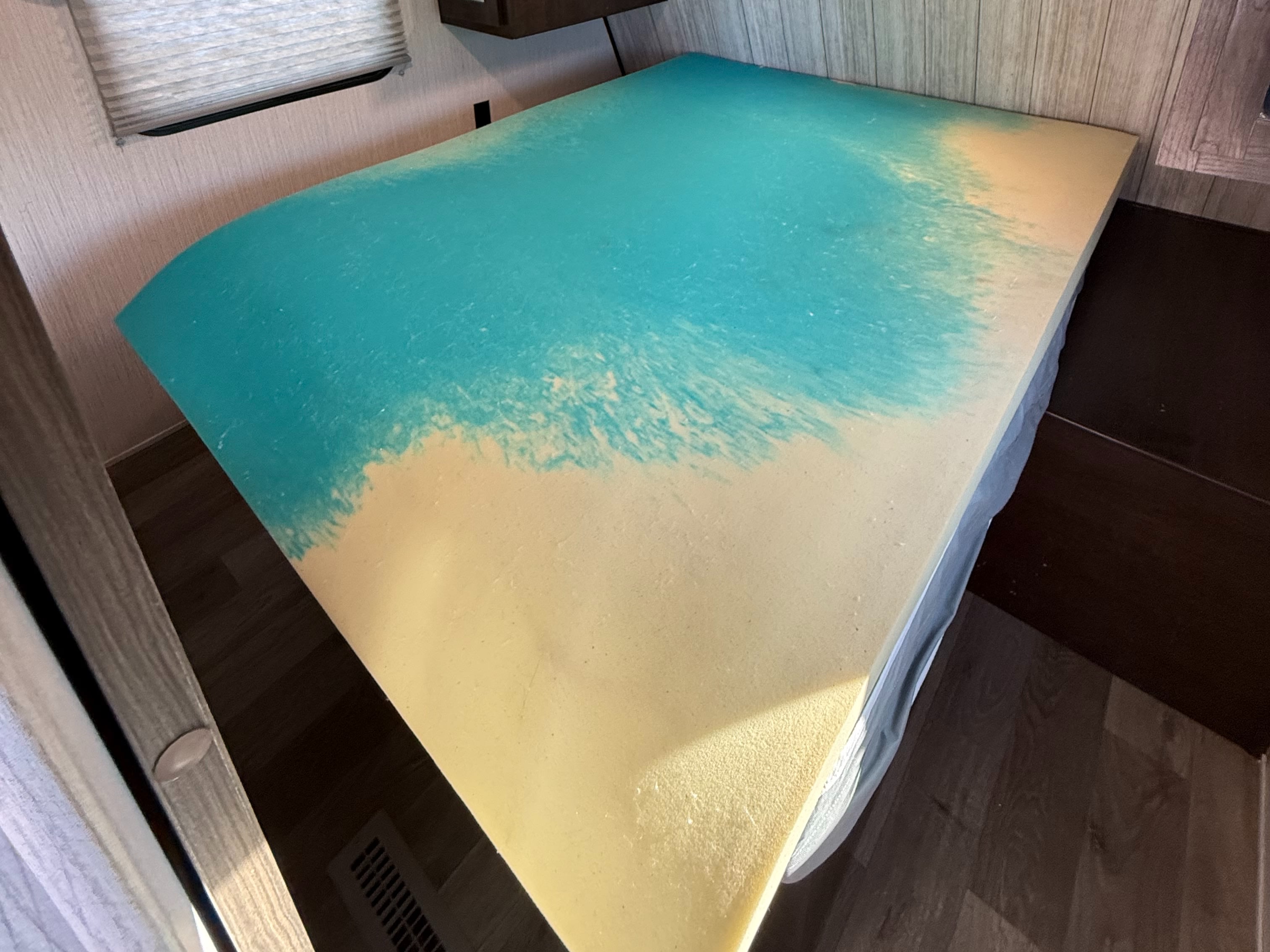 Enhance your rv rental comfort with this memory foam mattress topper, featuring a blue cooling gel layer on a yellow base.. Heartland RVs Pioneer 2021